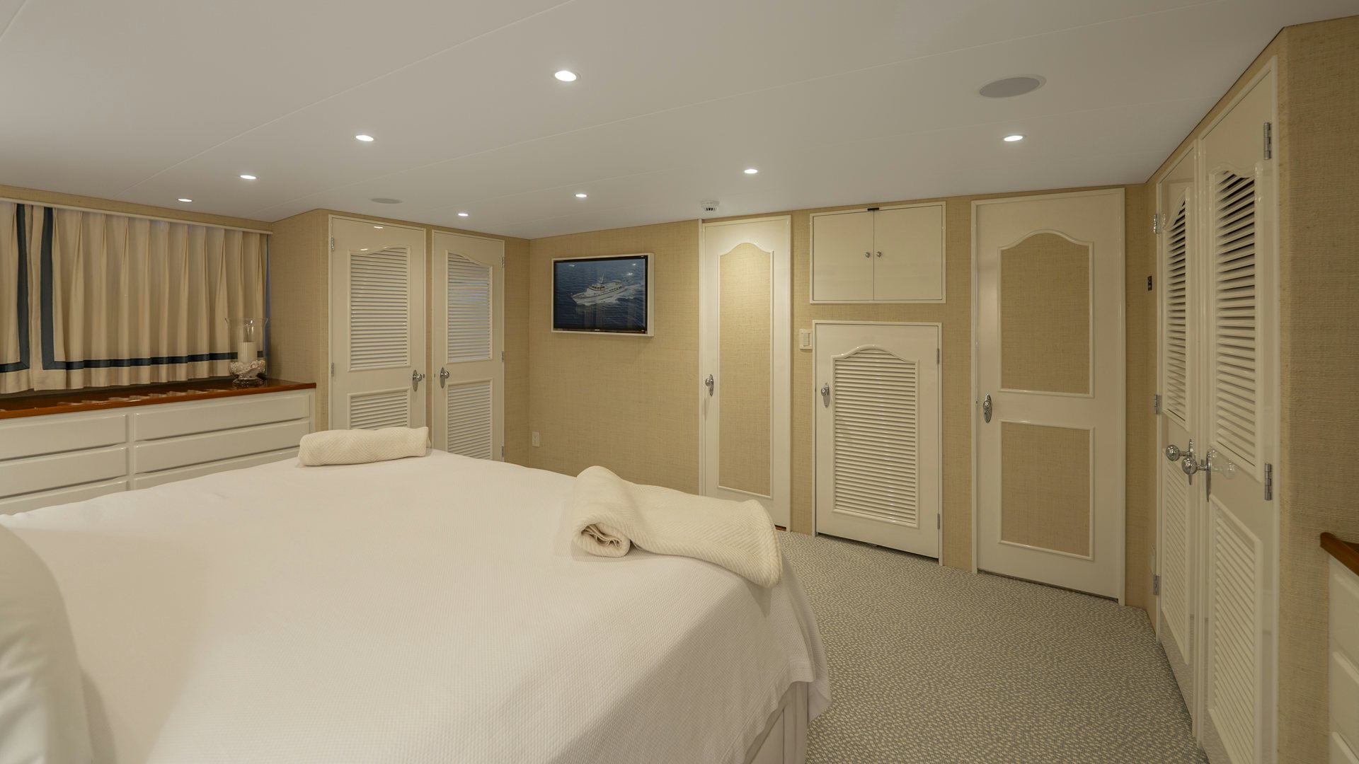 a bedroom with a bed and a door aboard STONEFACE Yacht for Sale