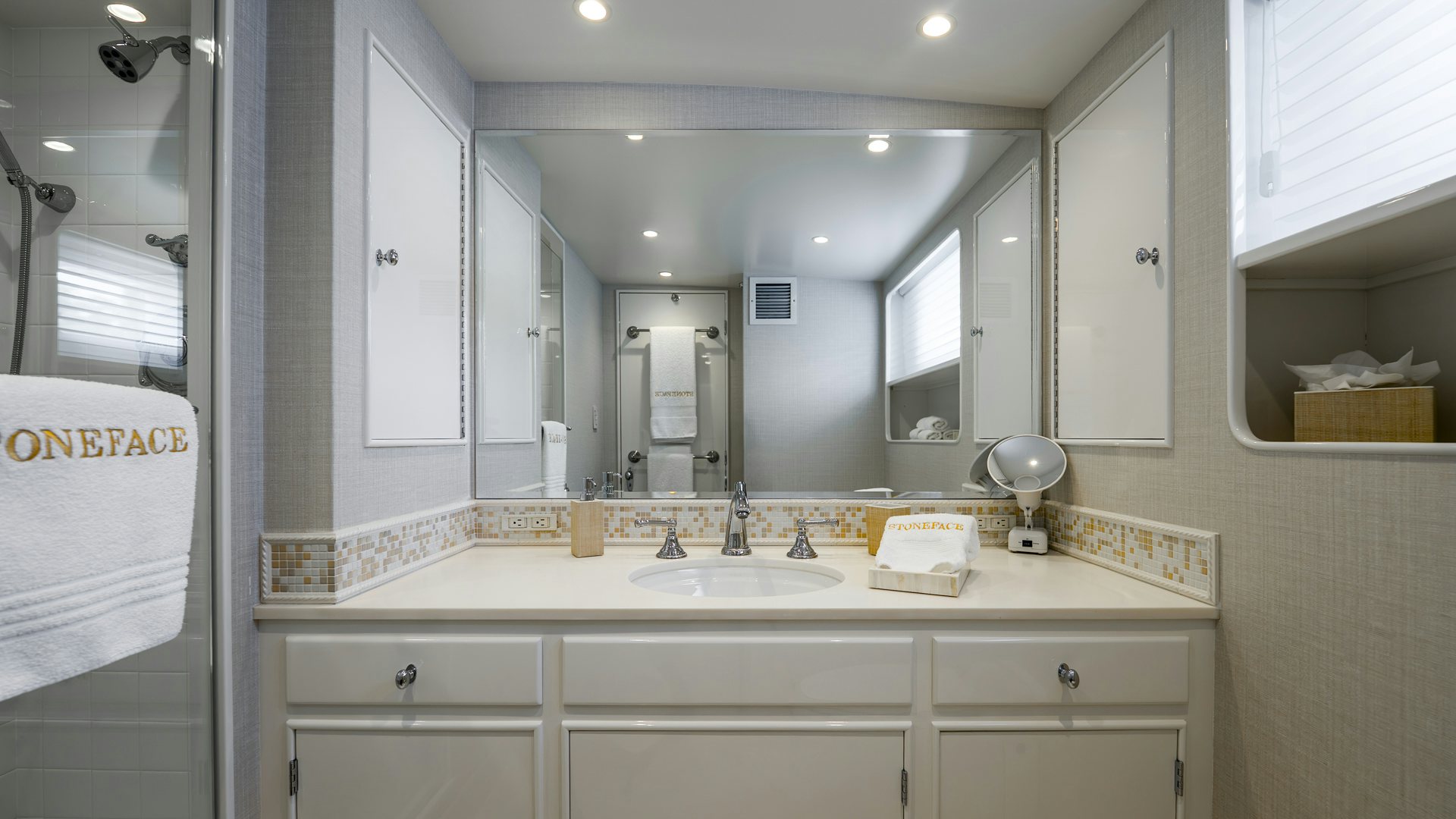 a bathroom with a large mirror aboard STONEFACE Yacht for Sale