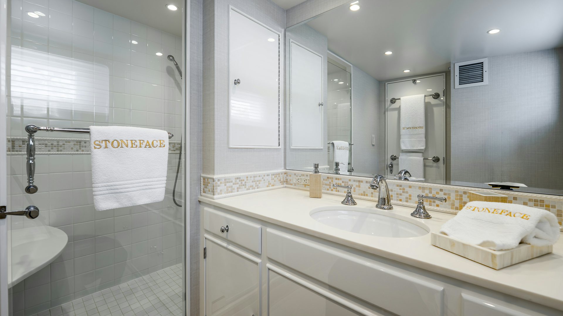 a bathroom with a glass shower aboard STONEFACE Yacht for Sale