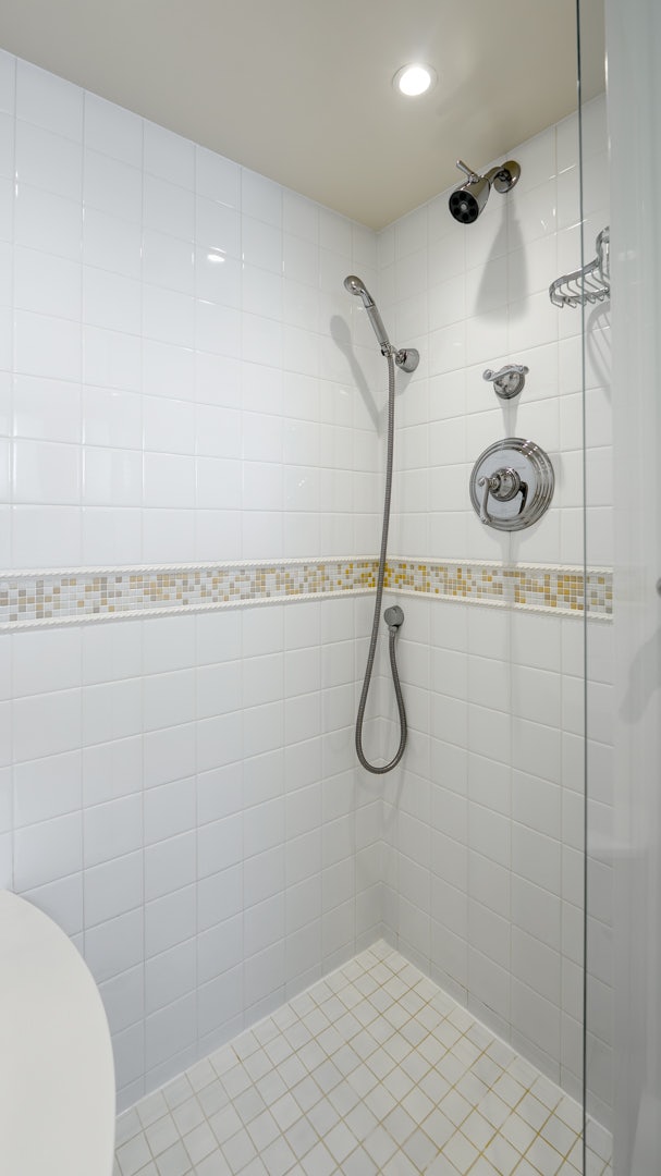 a shower with a tile floor aboard STONEFACE Yacht for Sale