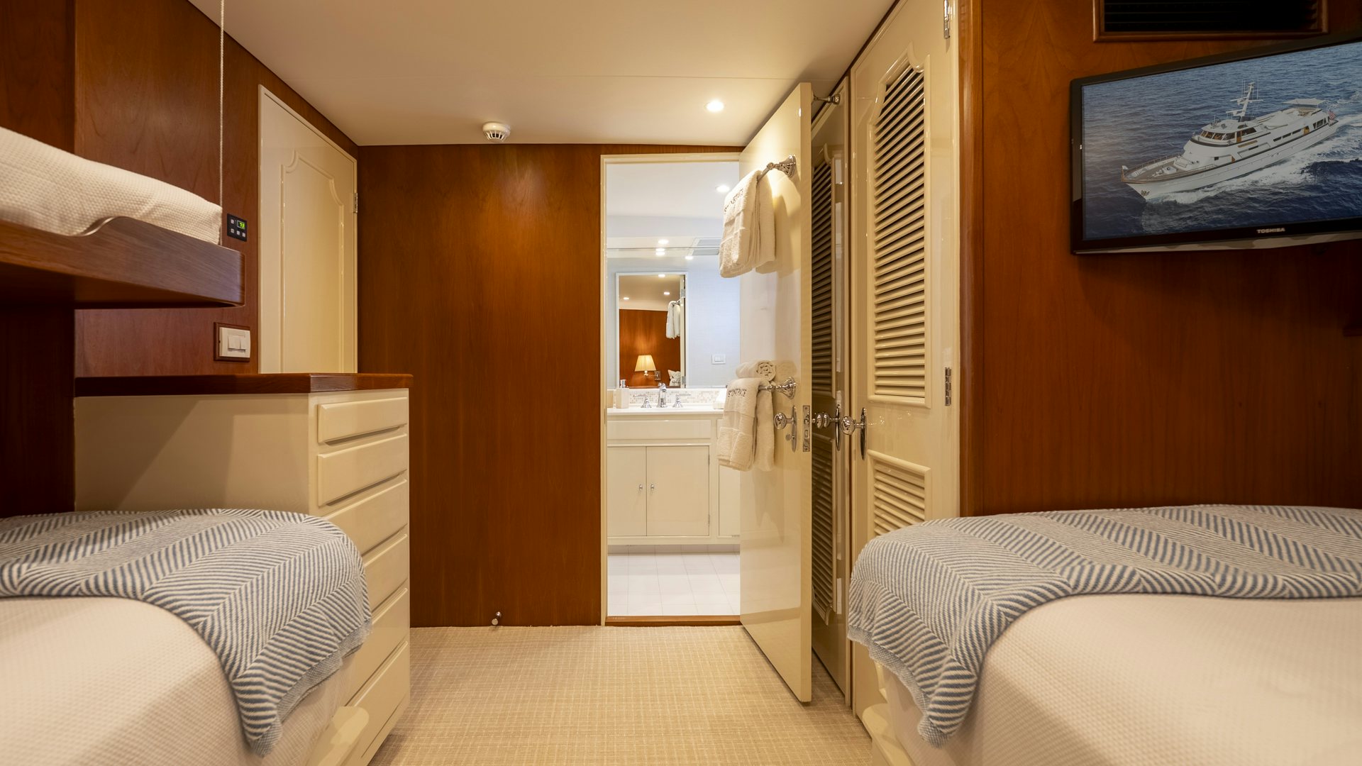 a room with a bed and a mirror aboard STONEFACE Yacht for Sale