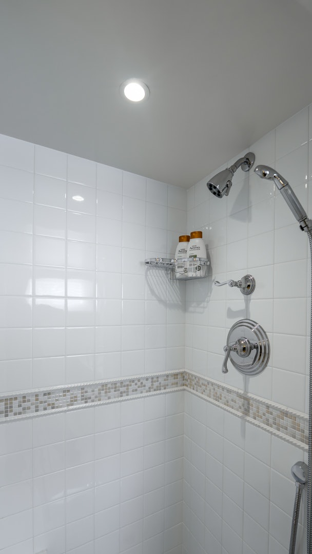 a shower with a tile wall aboard STONEFACE Yacht for Sale