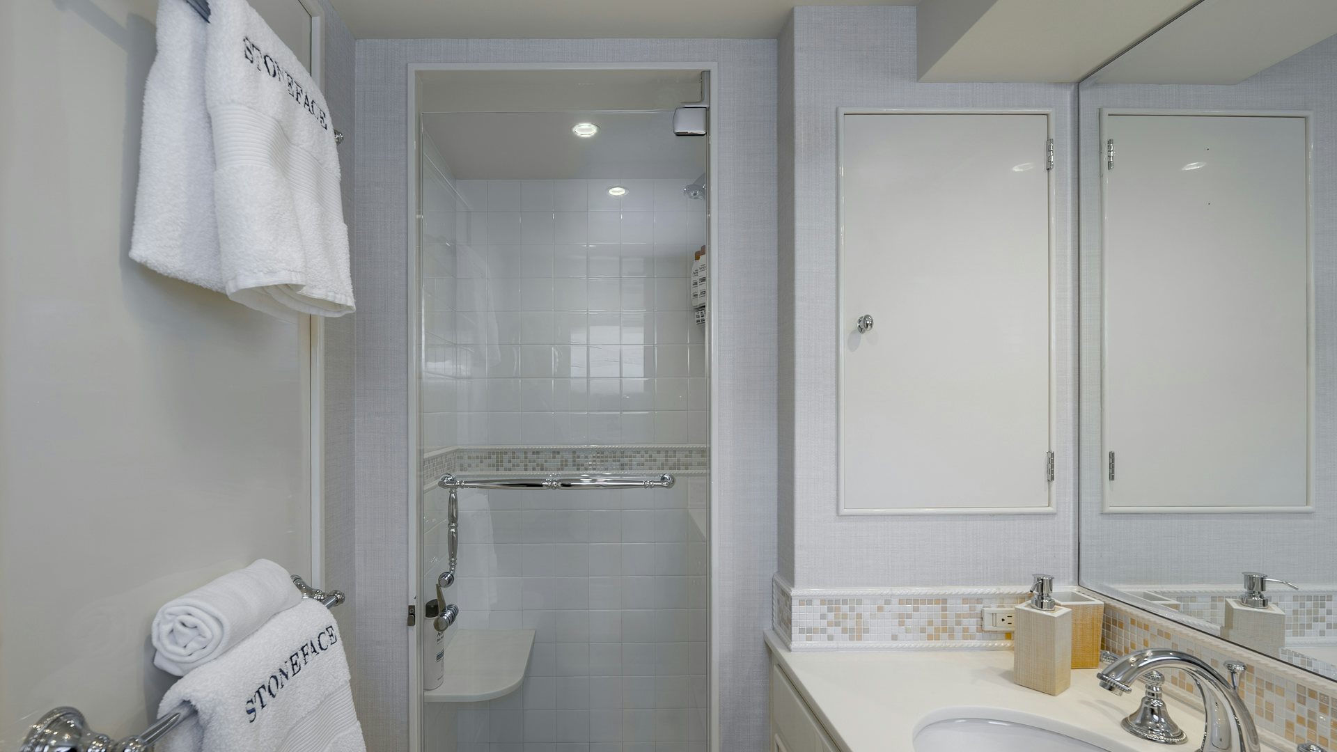 a bathroom with a shower unit and sink aboard STONEFACE Yacht for Sale