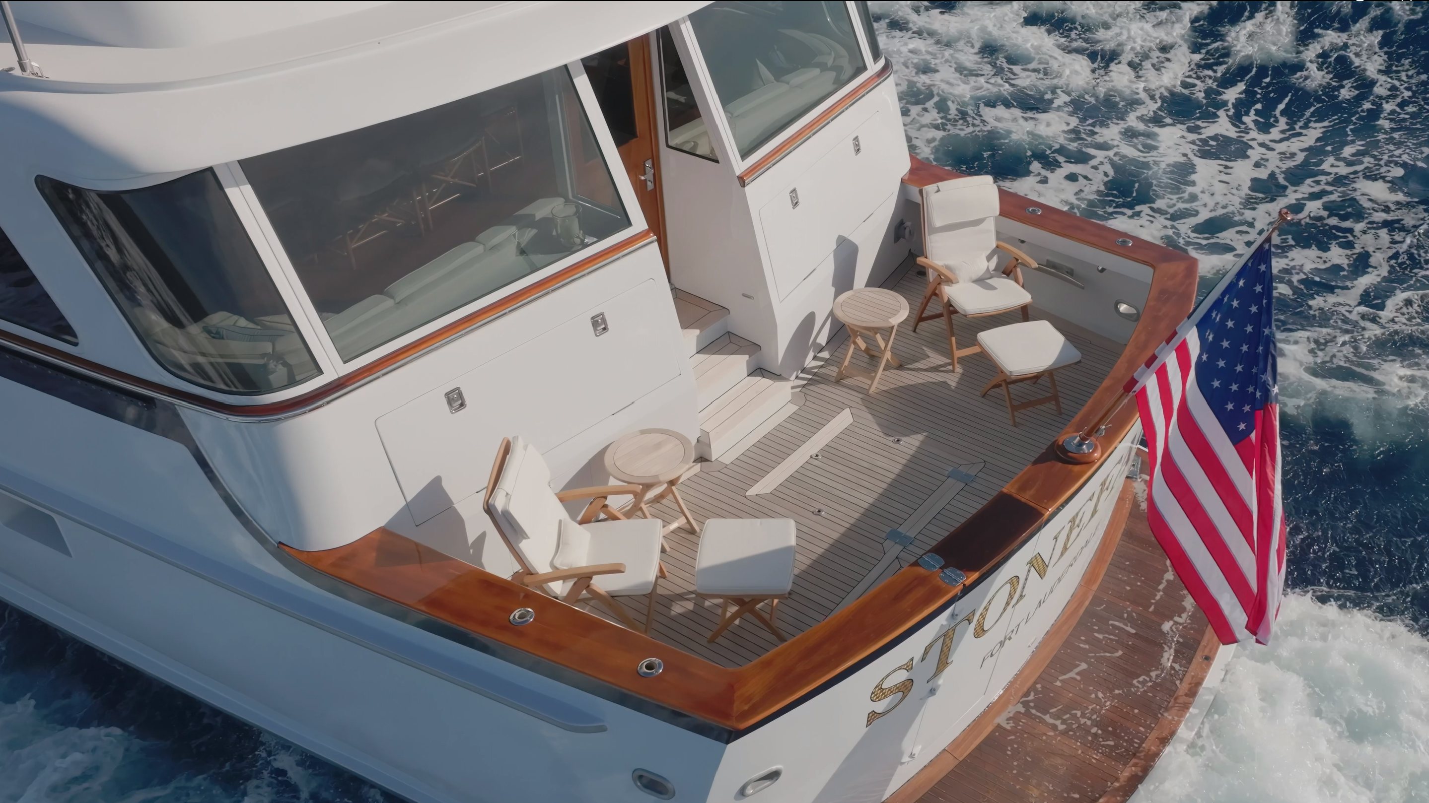 a boat with a flag on the front aboard STONEFACE Yacht for Sale