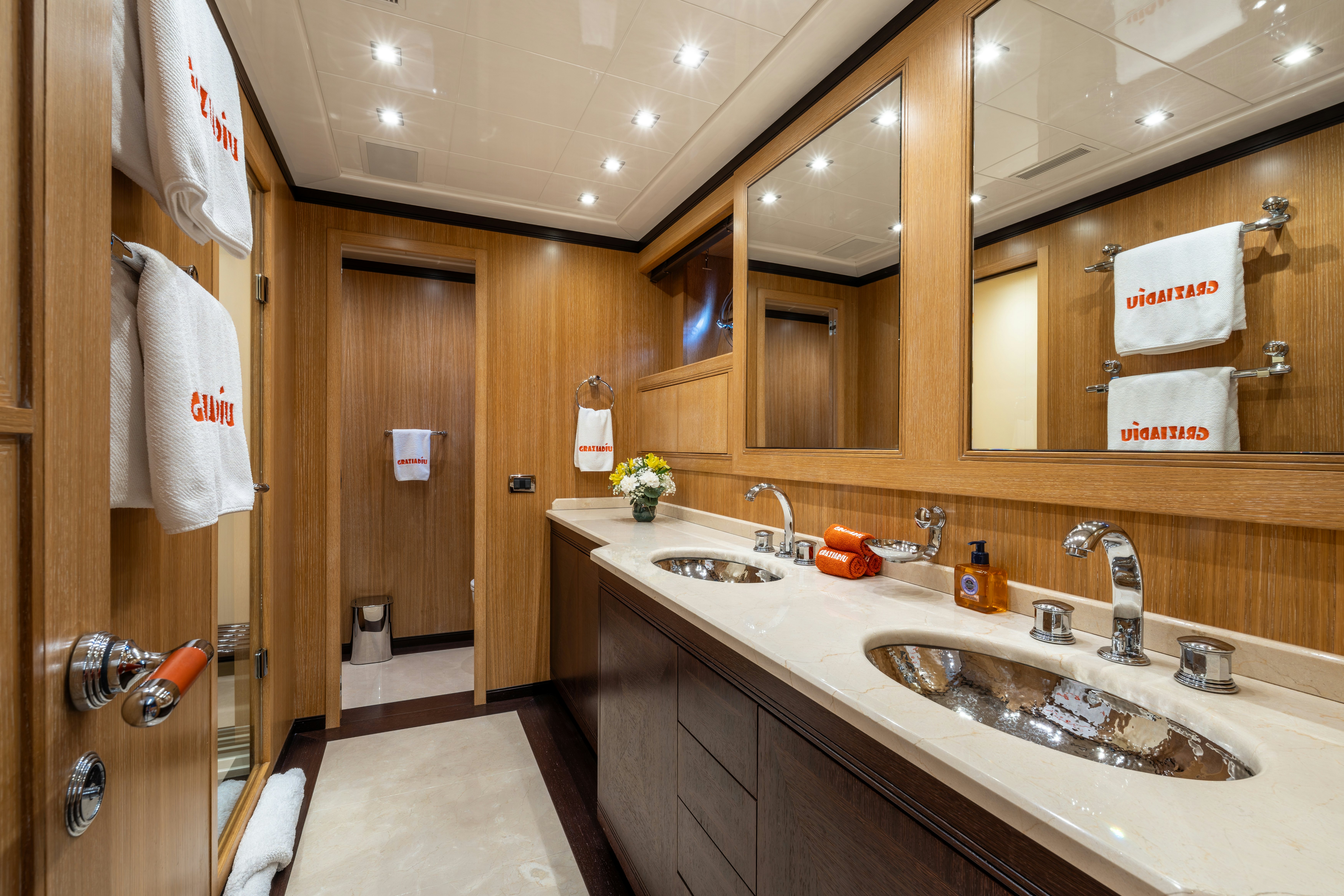 a bathroom with two sinks and mirrors aboard GRAZIADIU Yacht for Sale