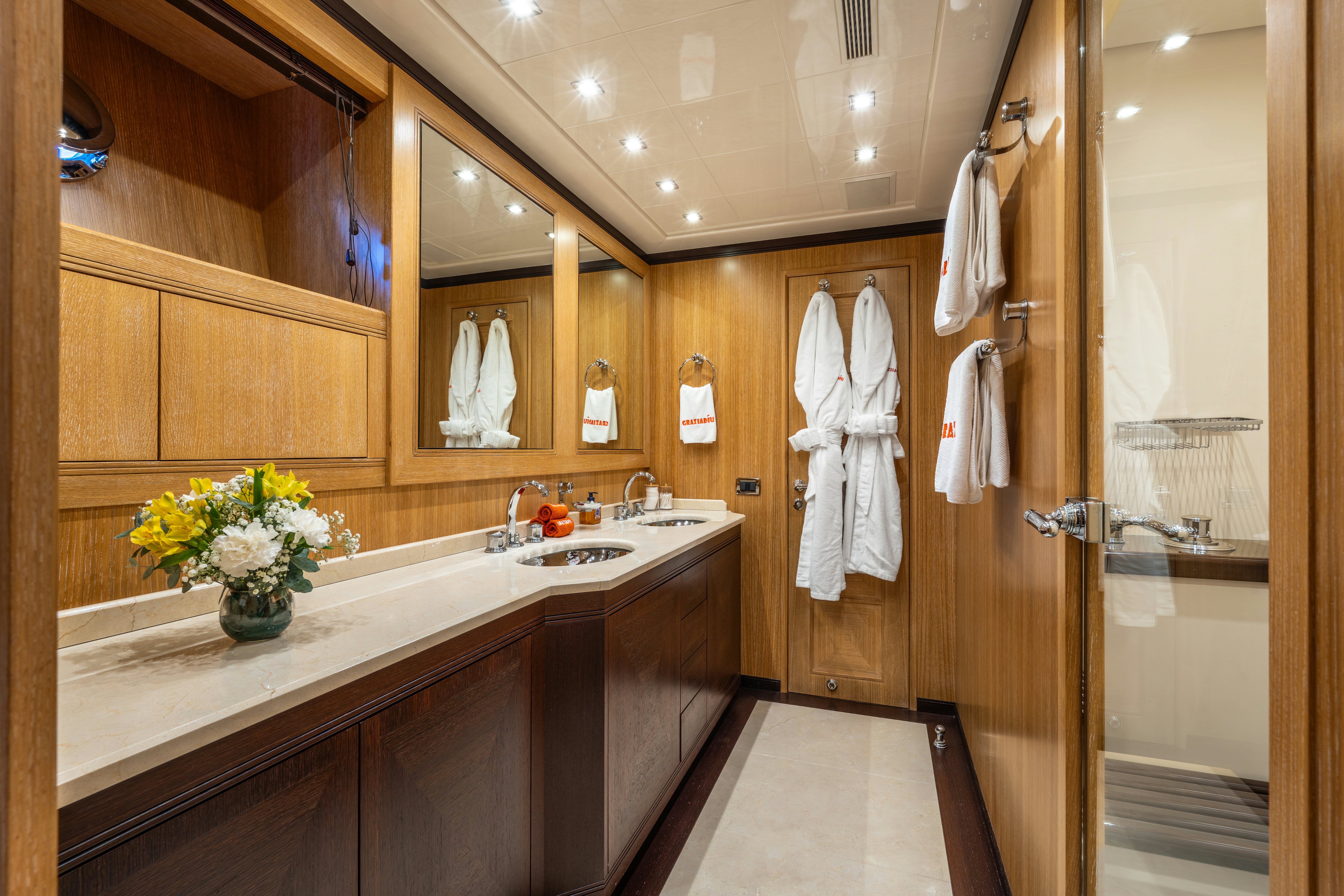 a bathroom with a large mirror aboard GRAZIADIU Yacht for Sale