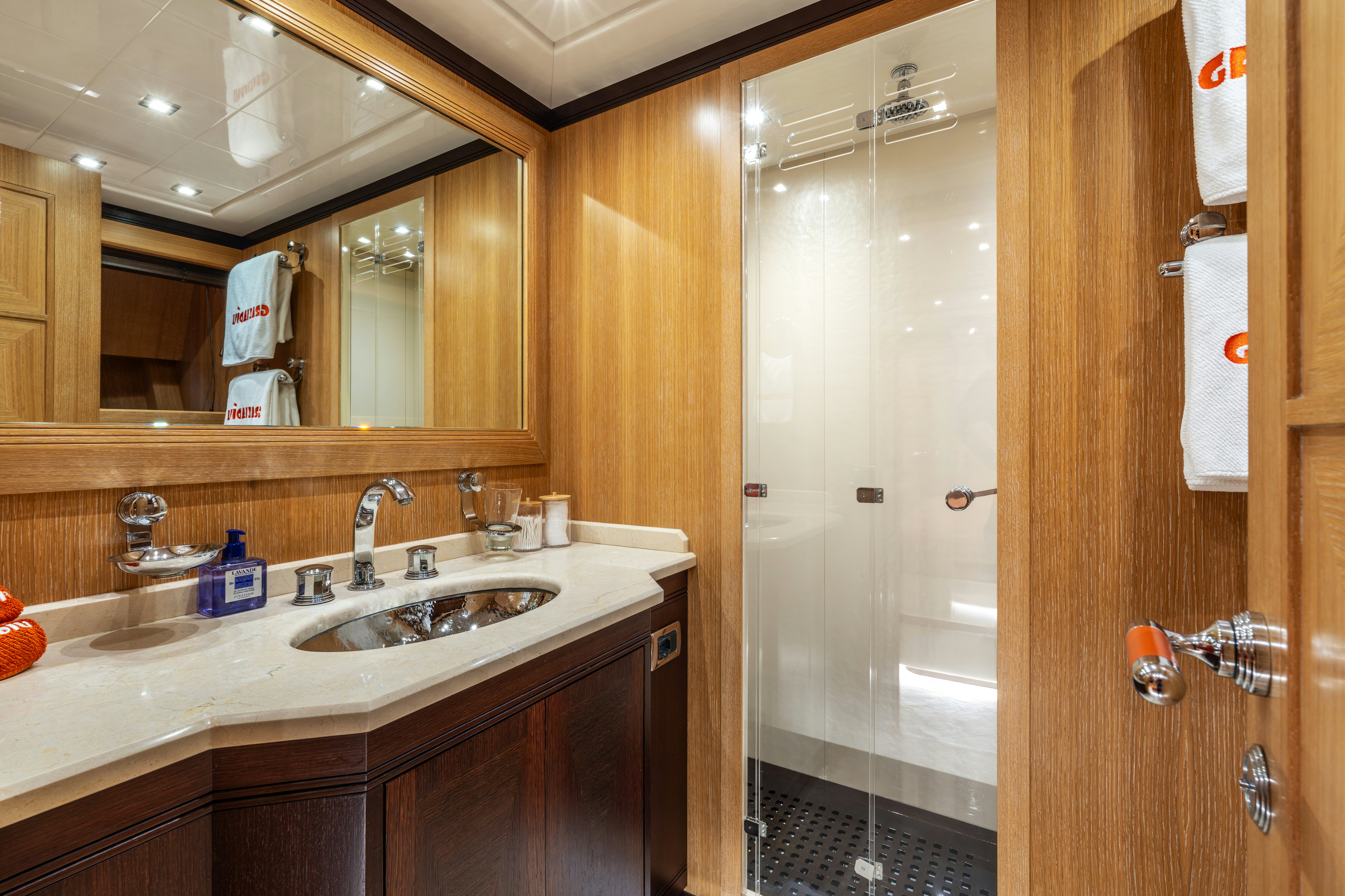 a bathroom with a sink and a mirror aboard GRAZIADIU Yacht for Sale