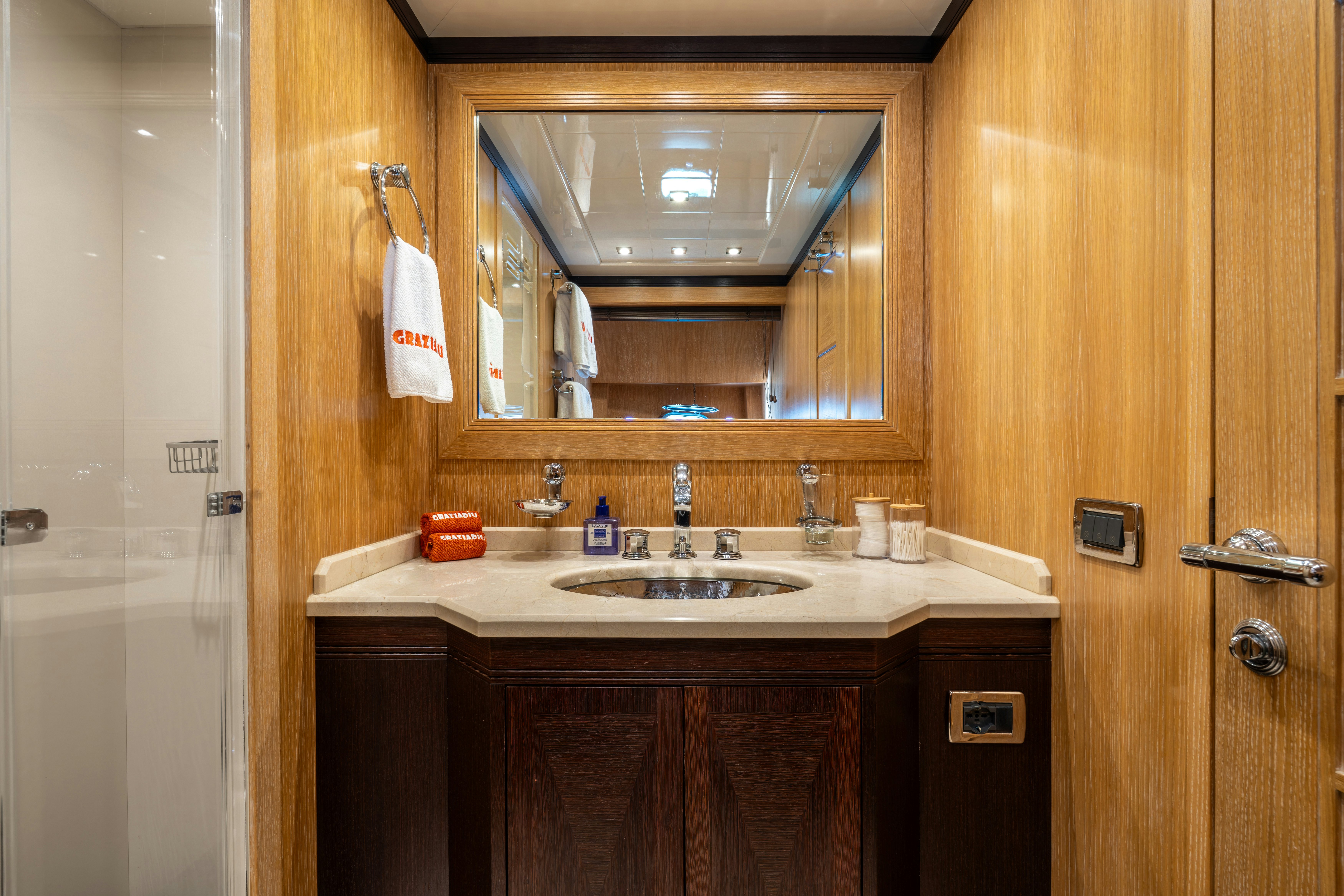 a bathroom with a large mirror aboard GRAZIADIU Yacht for Sale