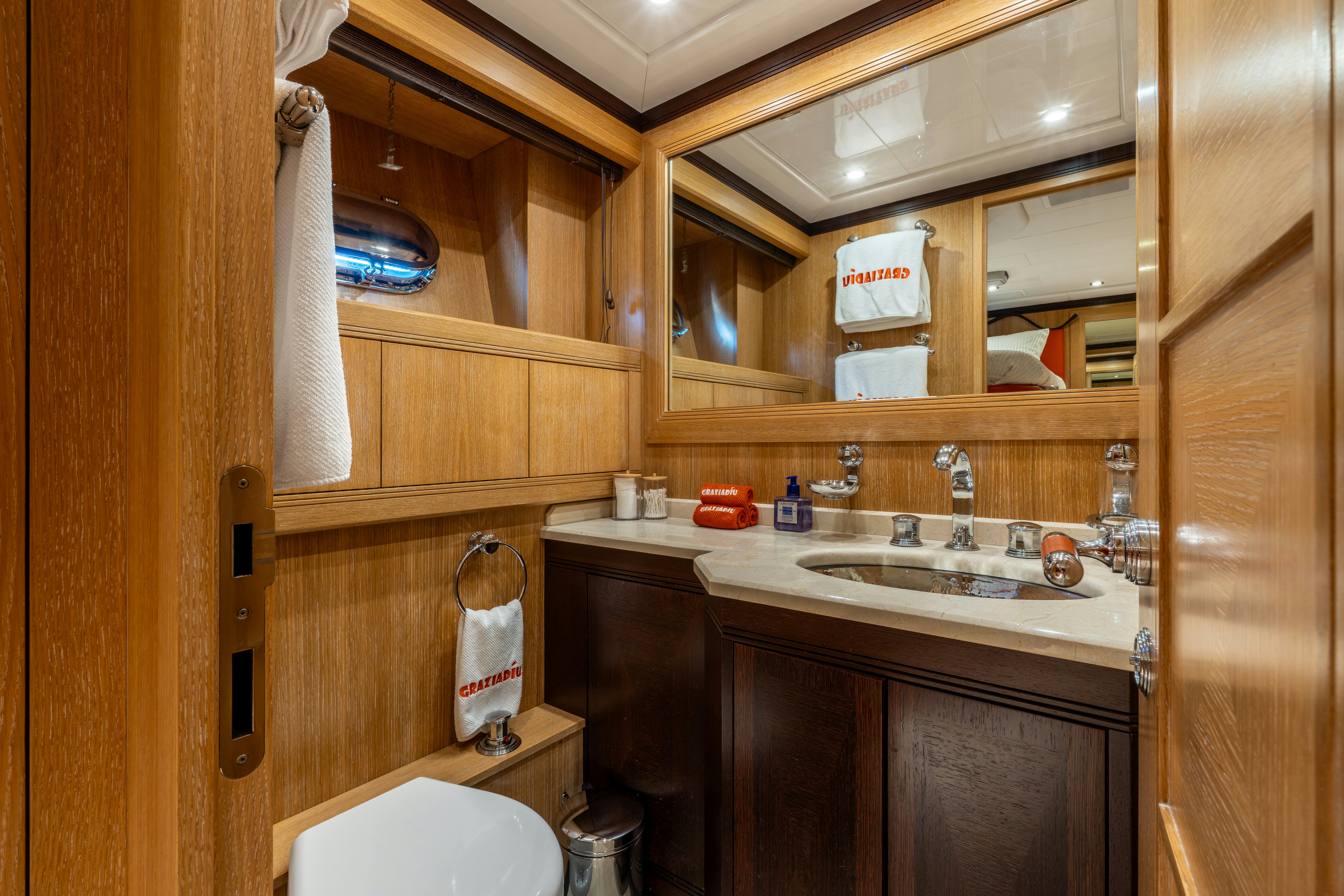 a bathroom with wooden cabinets aboard GRAZIADIU Yacht for Sale