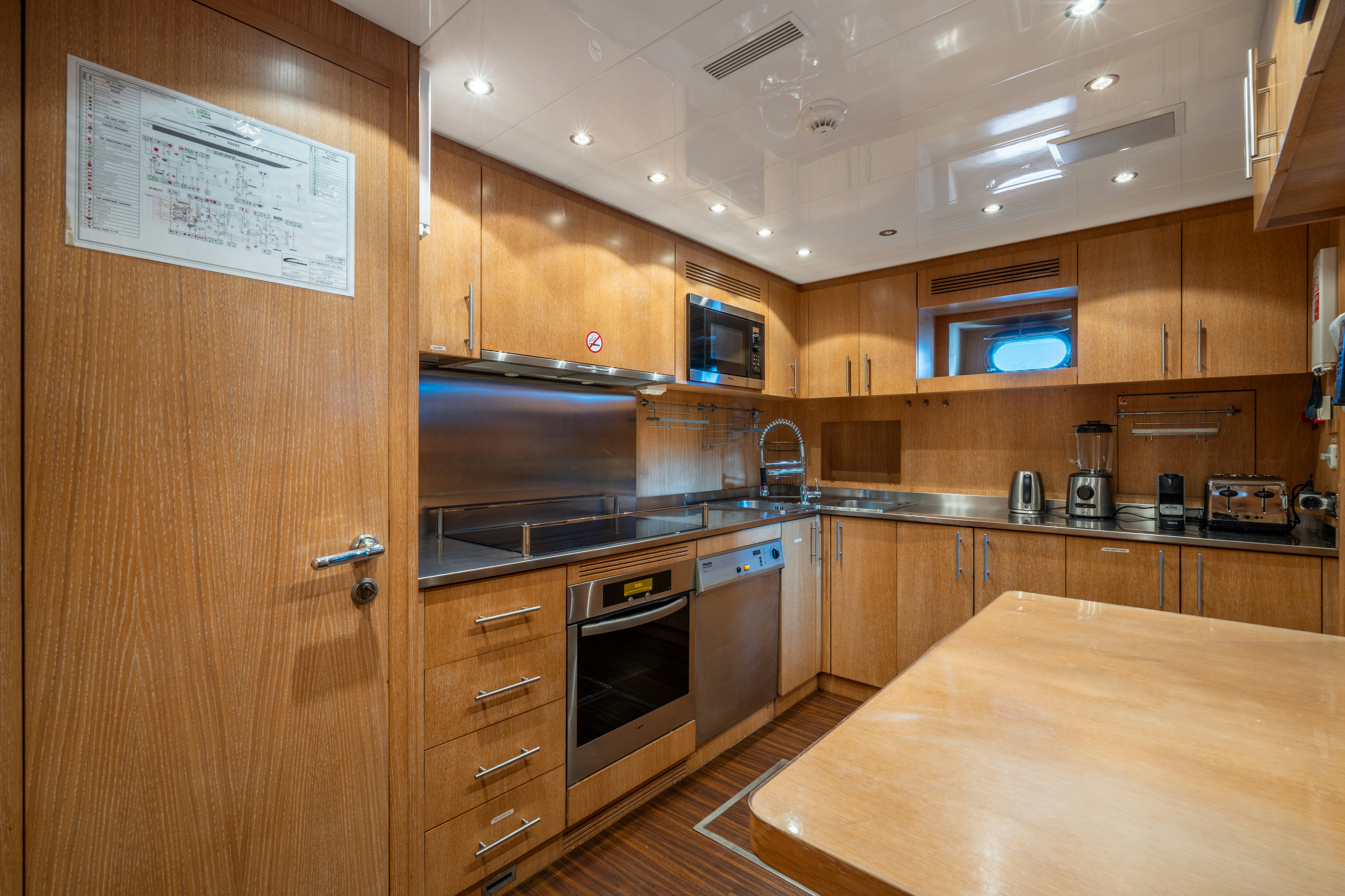 a kitchen with wooden cabinets aboard GRAZIADIU Yacht for Sale