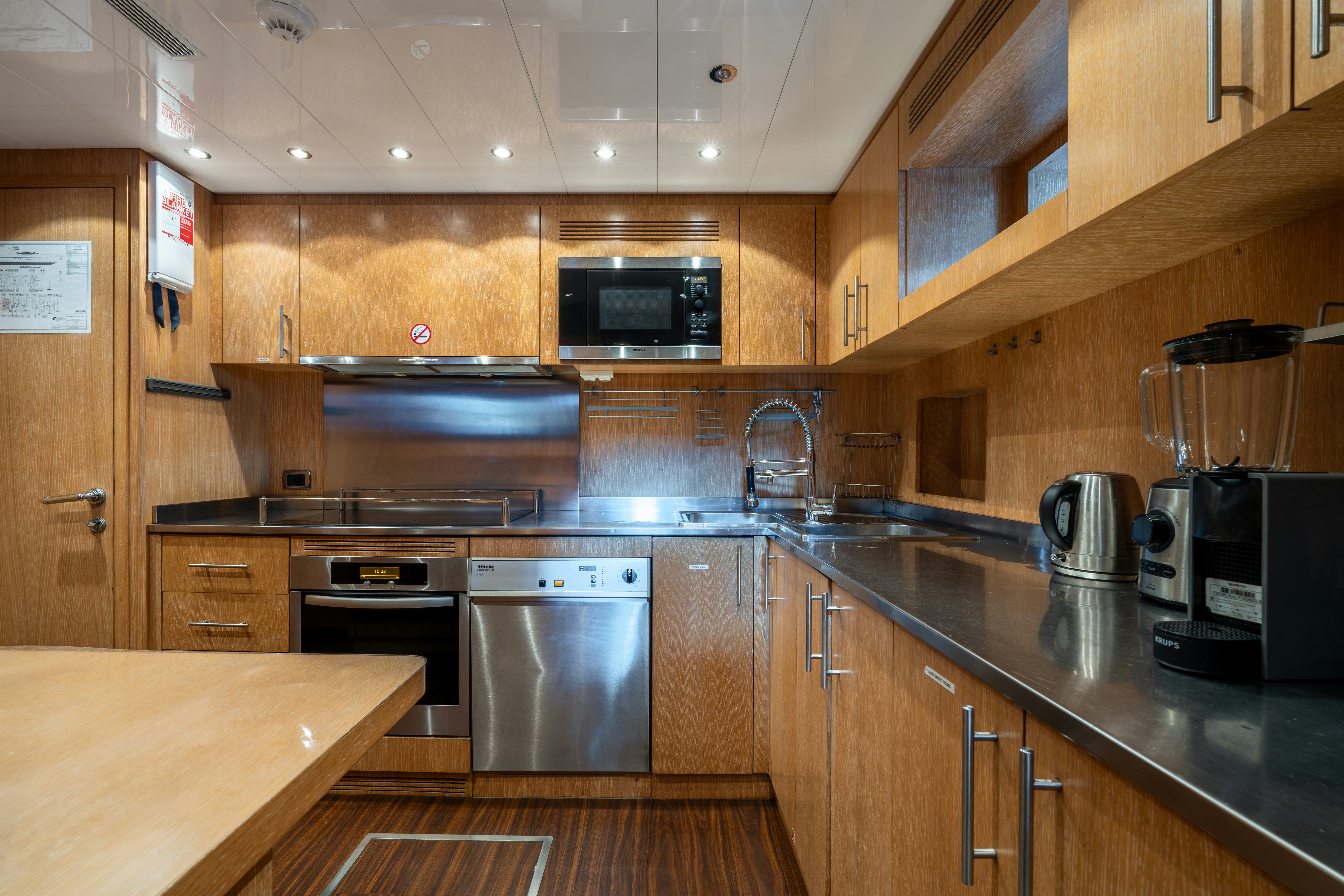 a kitchen with wooden cabinets aboard GRAZIADIU Yacht for Sale