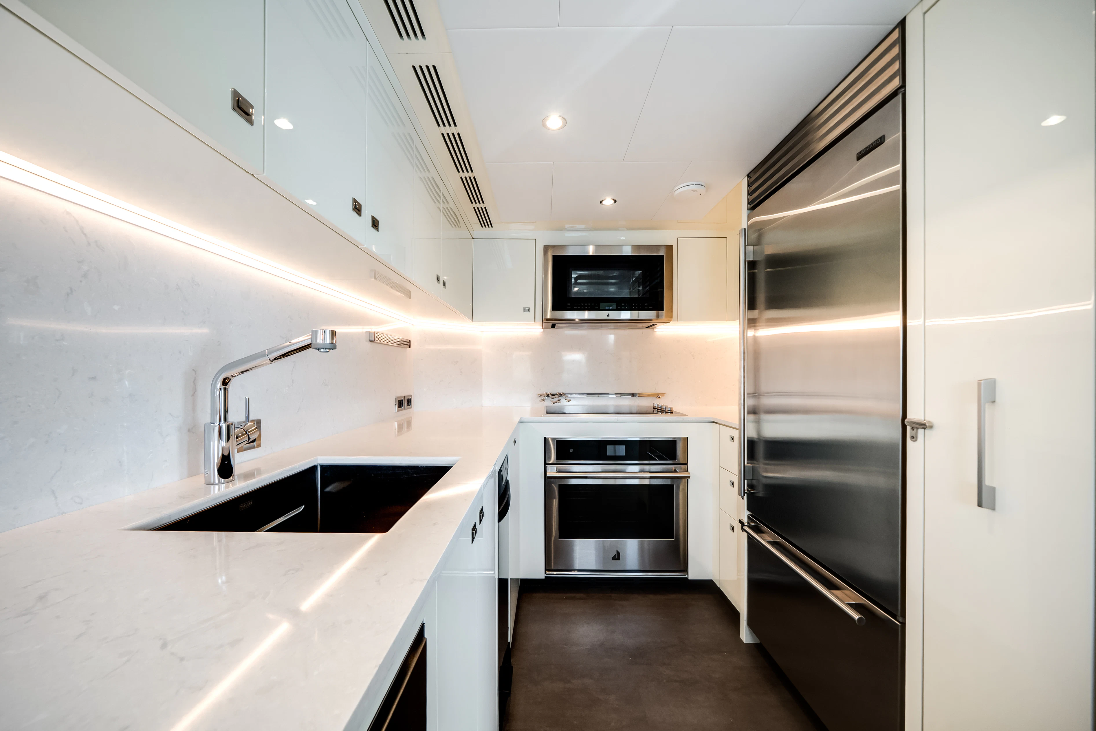 a kitchen with white cabinets aboard STILL WATERS Yacht for Sale