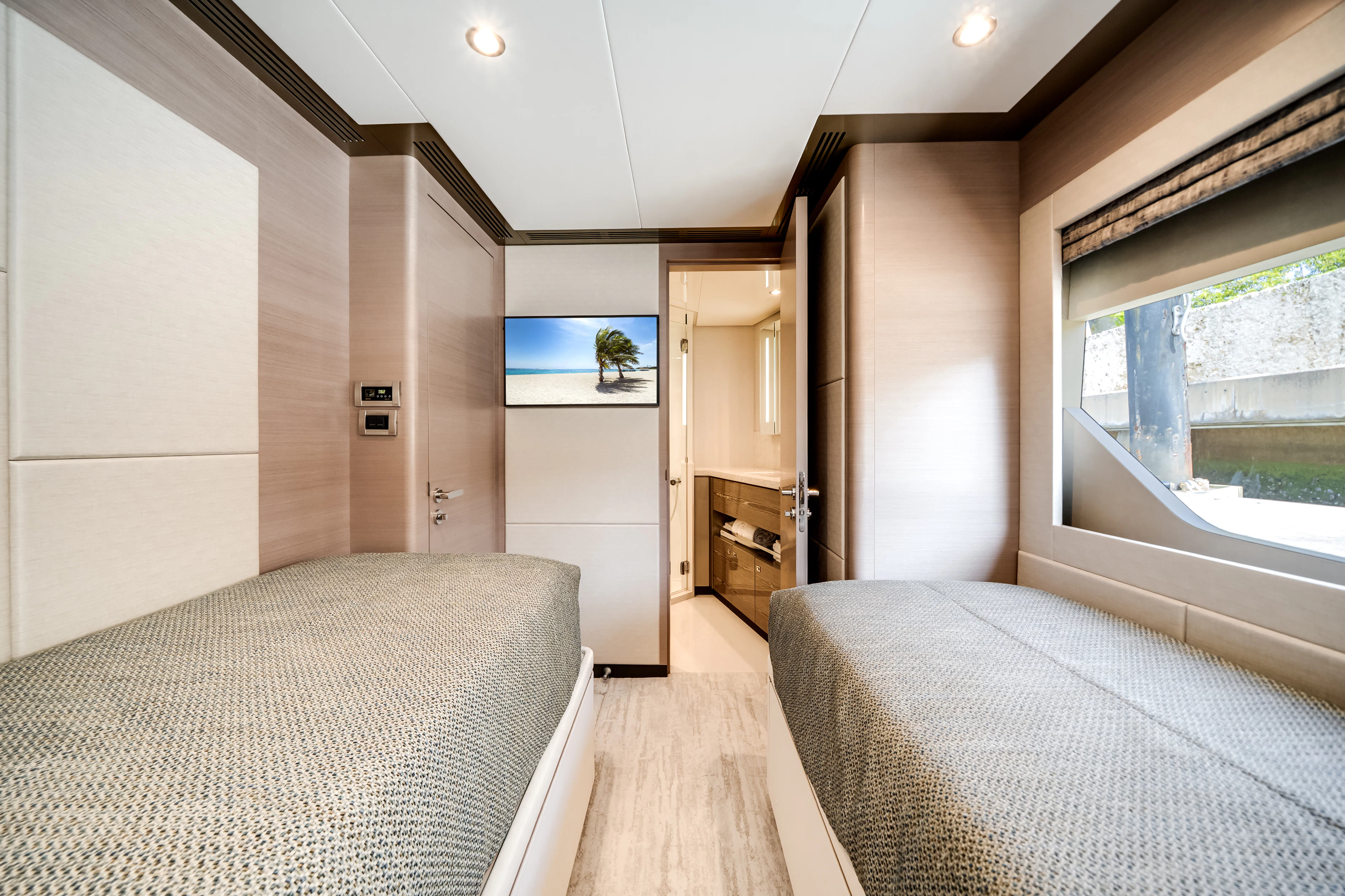 a bedroom with a bed and a window aboard STILL WATERS Yacht for Sale