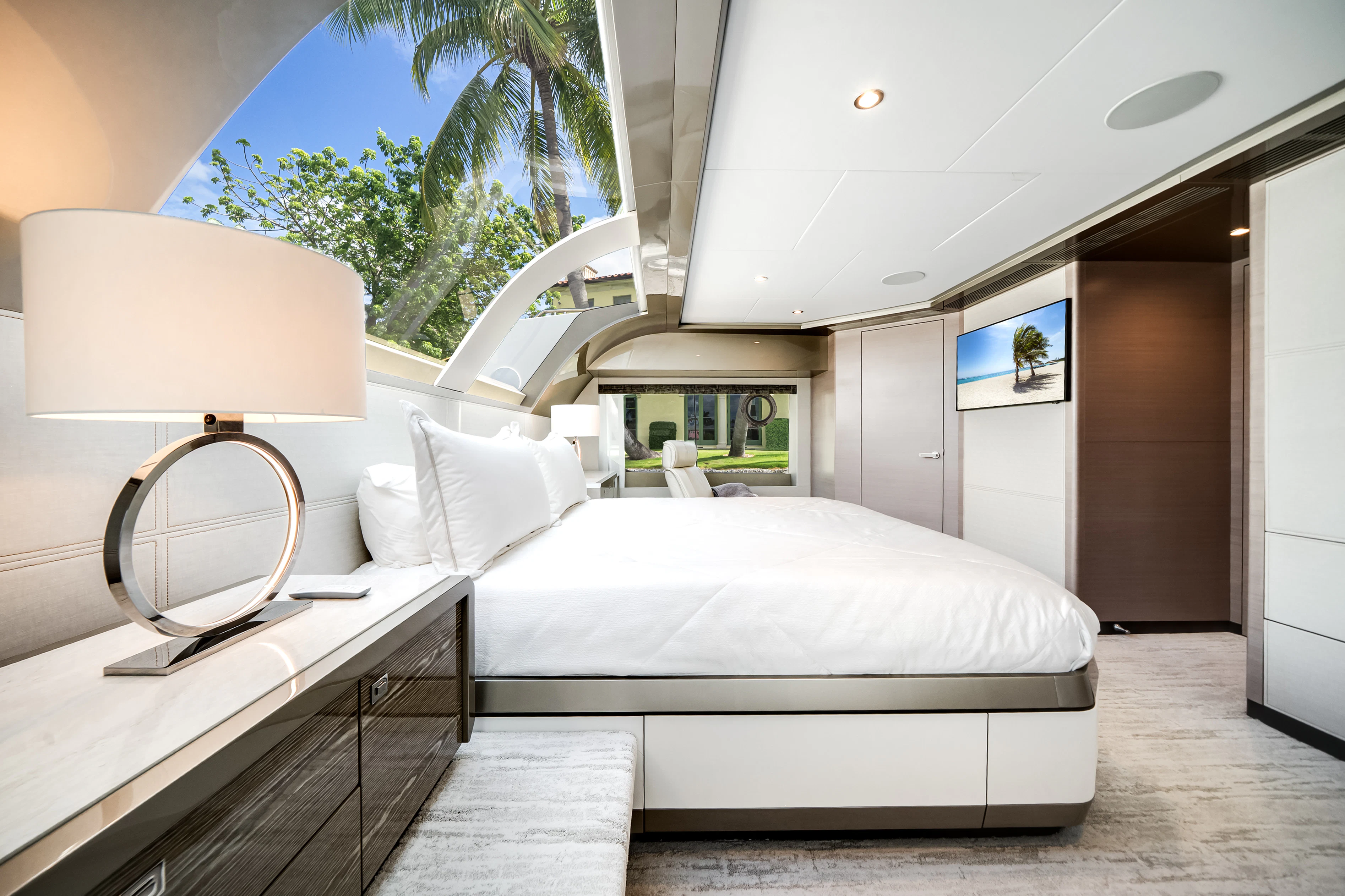 a room with a bed and a lamp aboard STILL WATERS Yacht for Sale