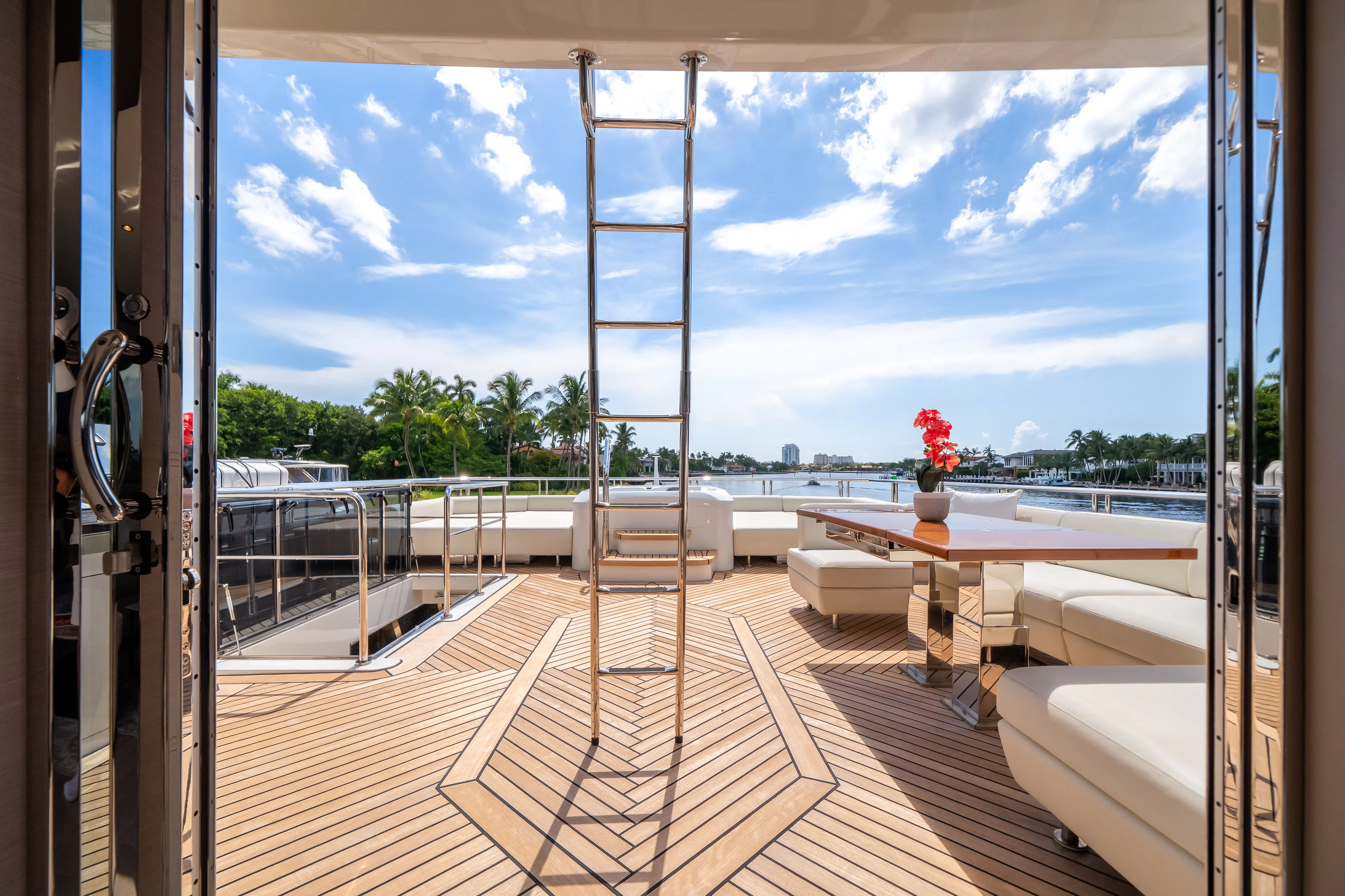 a deck with a view of the water and trees aboard STILL WATERS Yacht for Sale