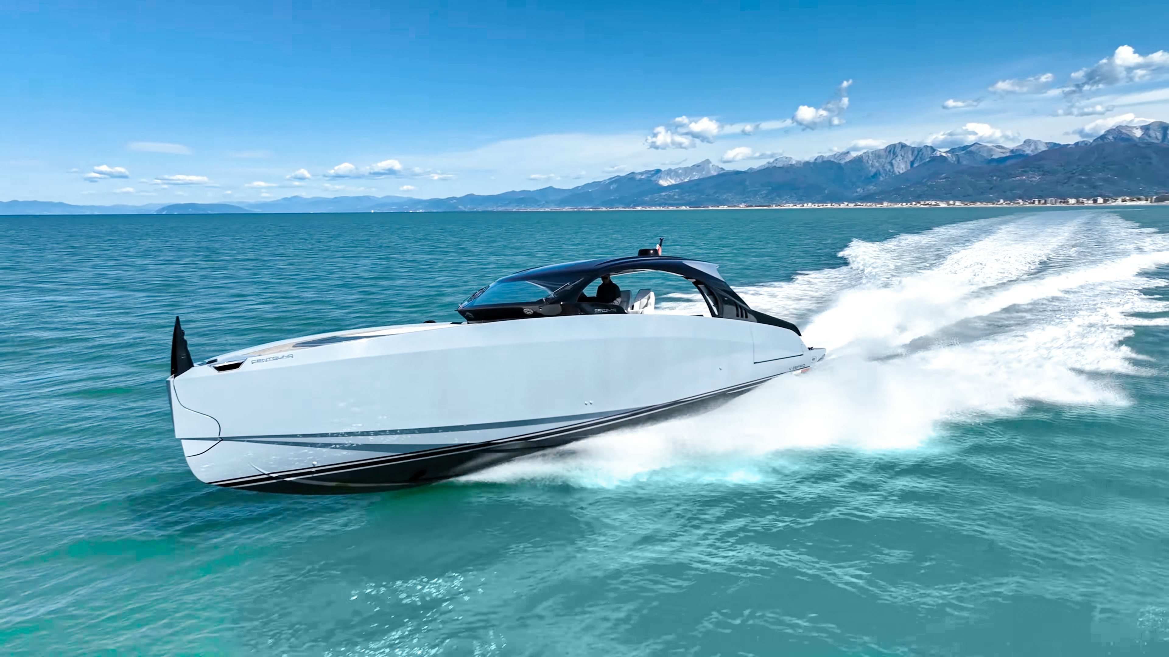 a white car driving in the water aboard VESPRO 55 Yacht for Sale