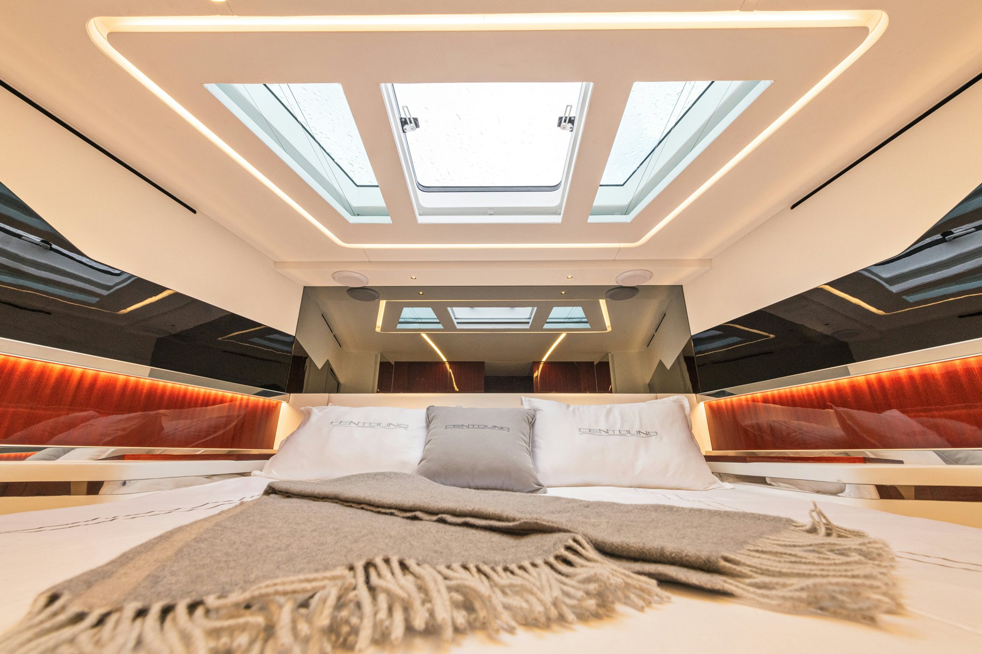 a bed with a ceiling fan aboard VESPRO 55 Yacht for Sale