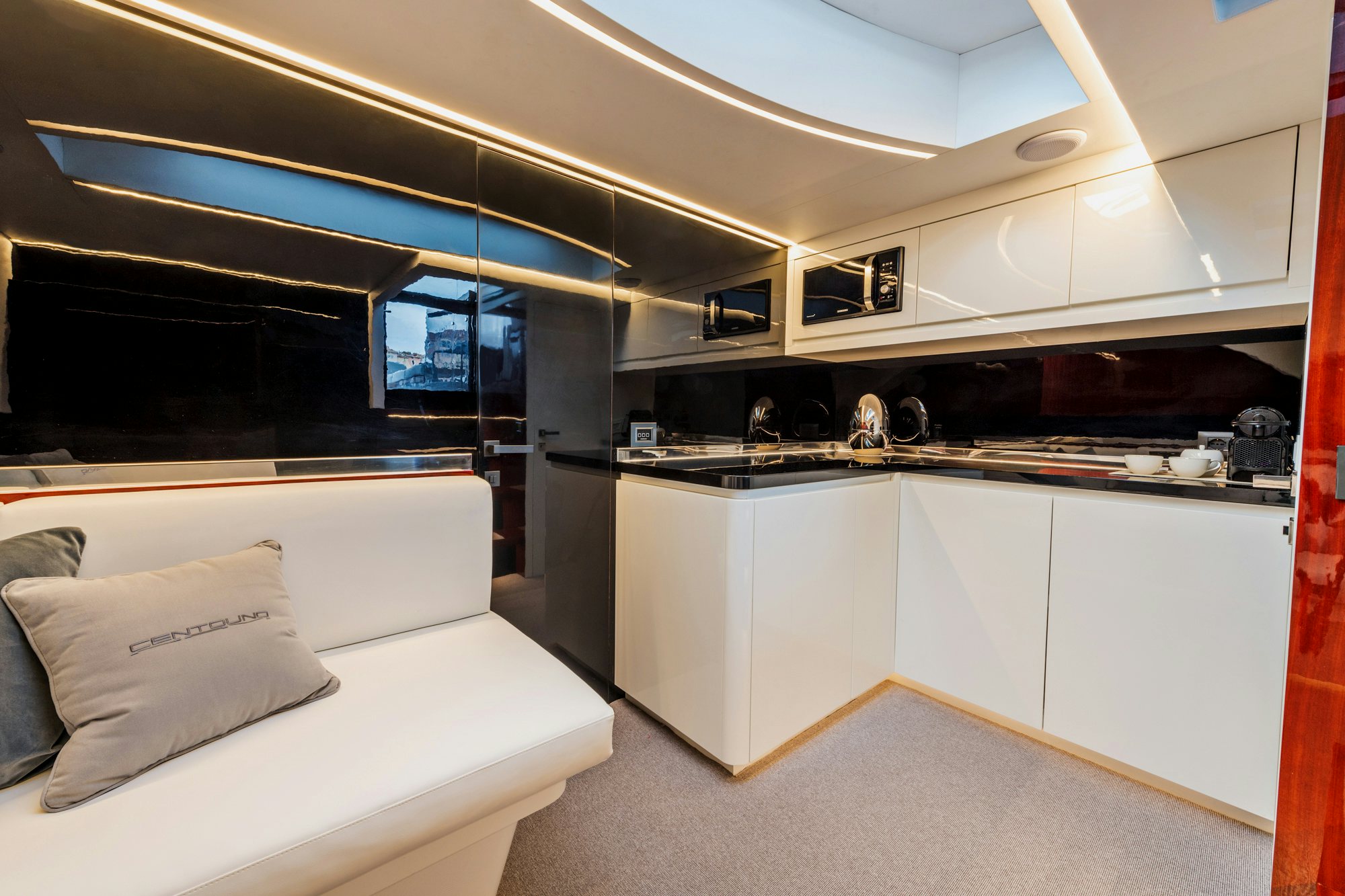a room with a couch and a sink aboard VESPRO 55 Yacht for Sale
