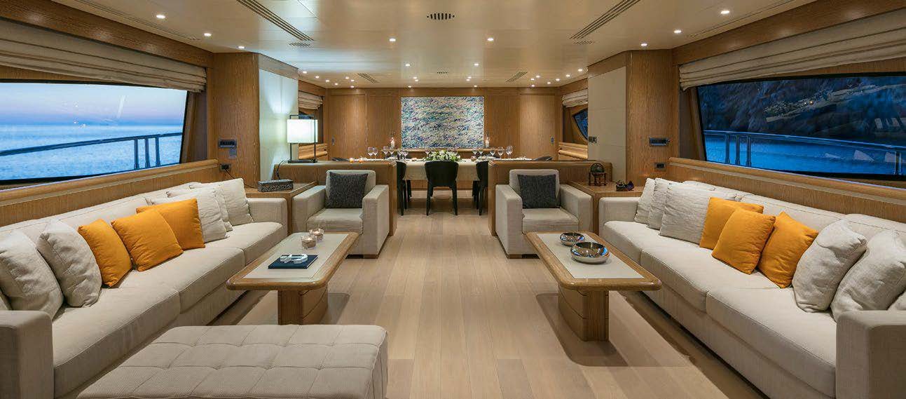a living room with a couch and a coffee table aboard RINI V Yacht for Charter