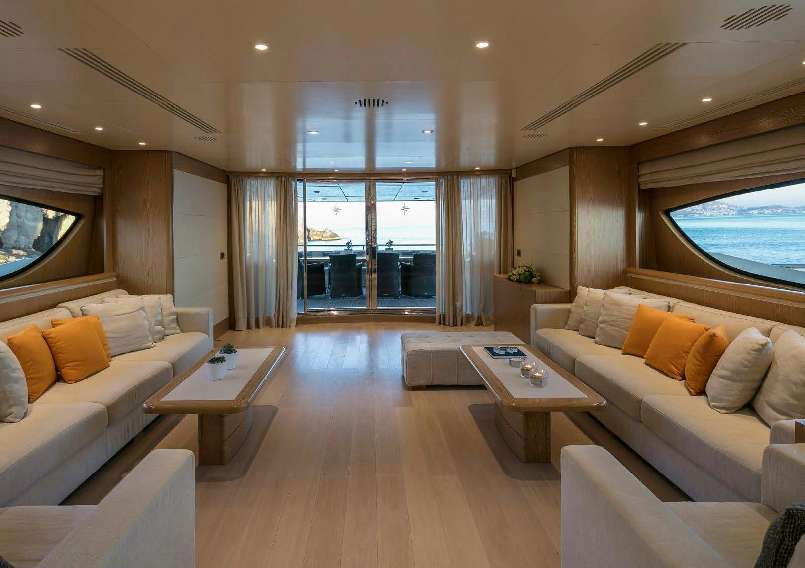 a living room with a large window aboard RINI V Yacht for Charter