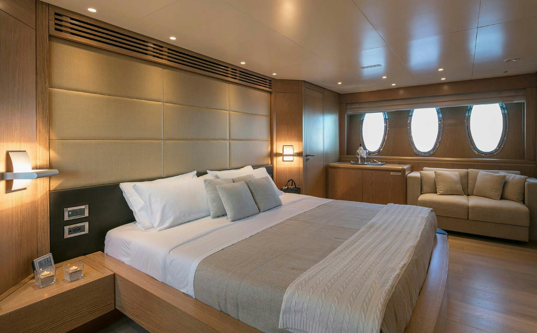 a bed with a white bed aboard RINI V Yacht for Charter
