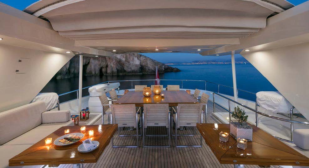 a room with a table and chairs aboard RINI V Yacht for Charter