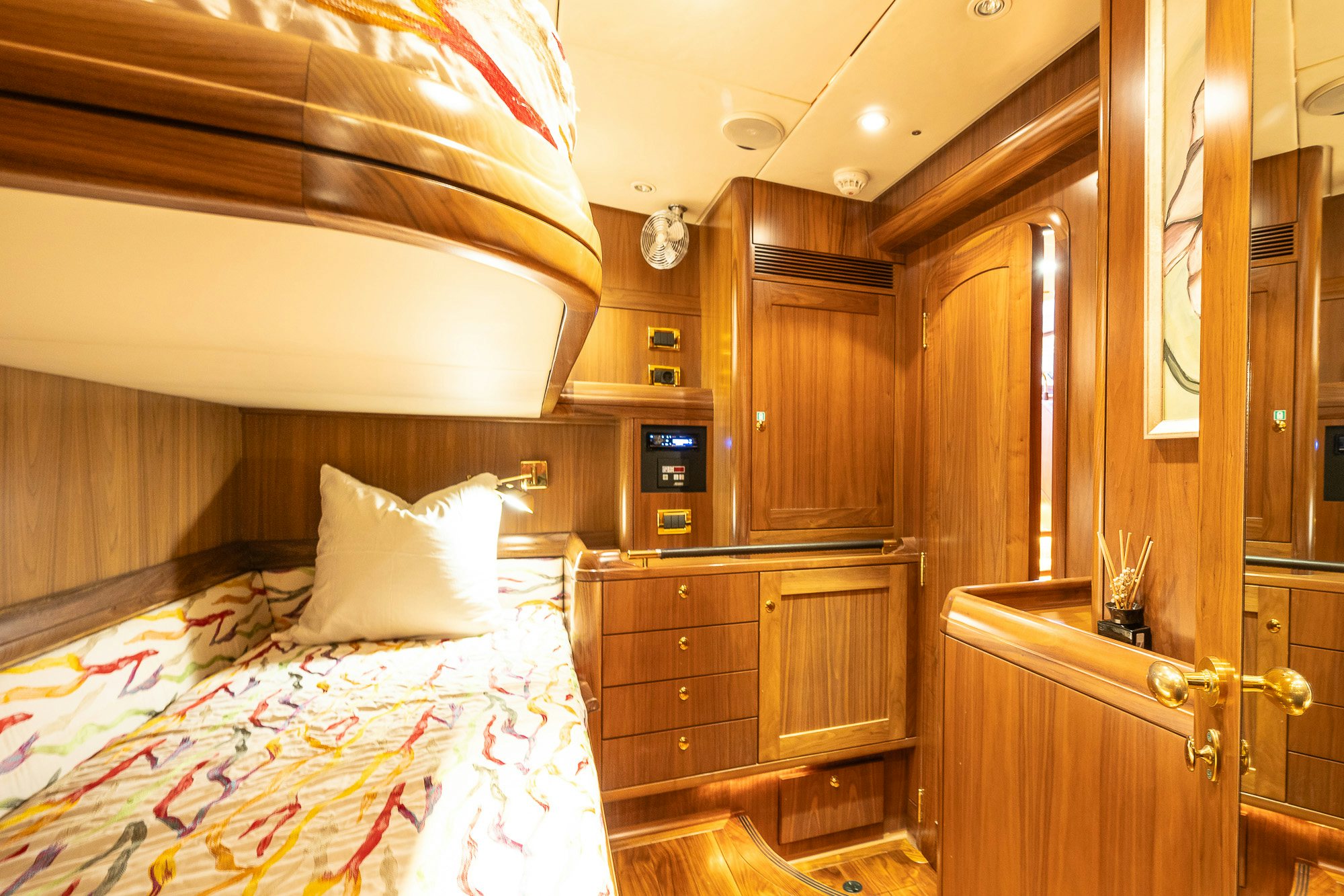 a bedroom with wood cabinets aboard ADESA Yacht for Sale