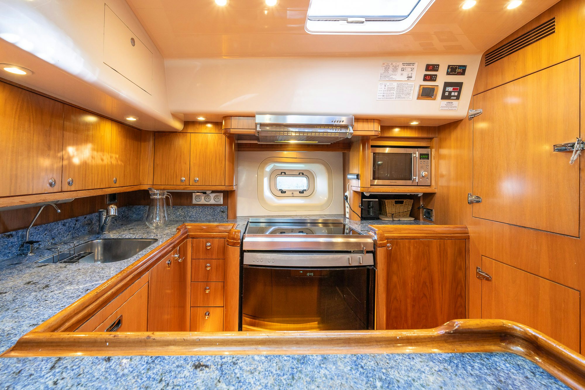 a kitchen with wooden cabinets aboard ADESA Yacht for Sale