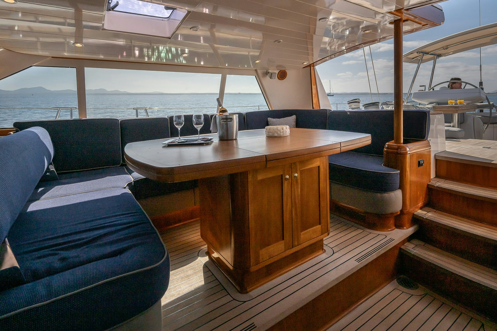 a boat with a table and chairs aboard ADESA Yacht for Sale