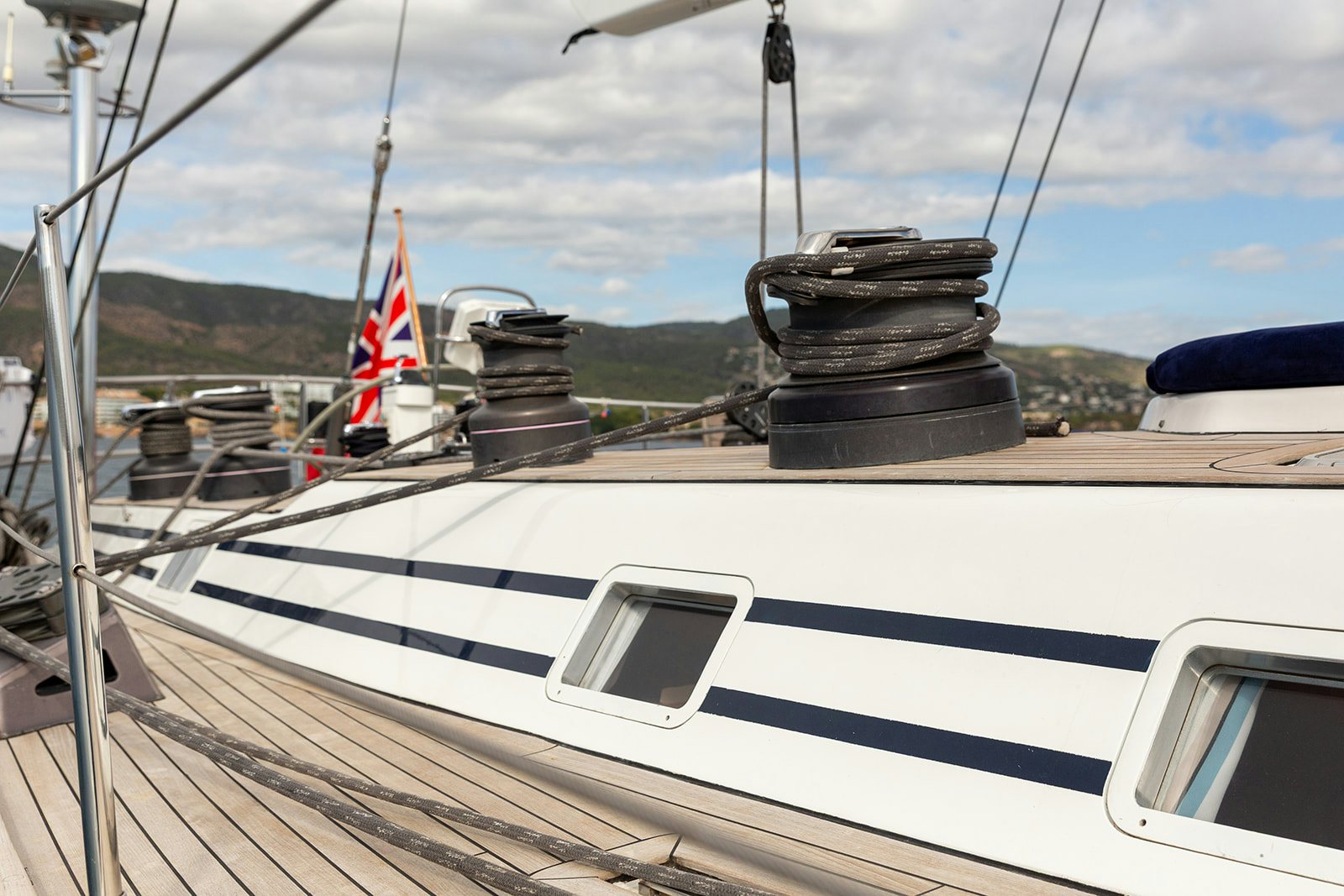 a boat with a flag on the front aboard DAG Yacht for Sale
