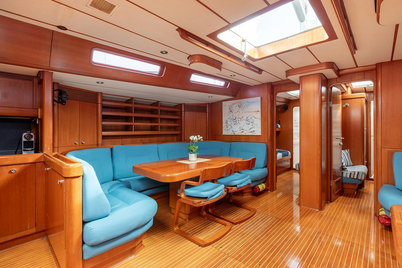 a room with a table and chairs aboard DAG Yacht for Sale