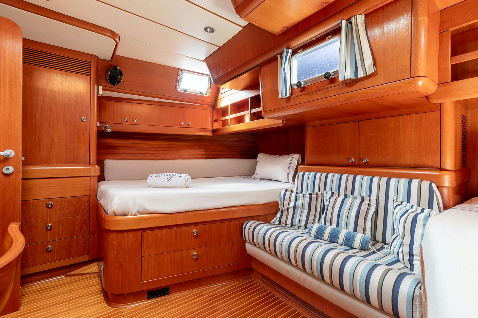 a room with a bed and a couch aboard DAG Yacht for Sale