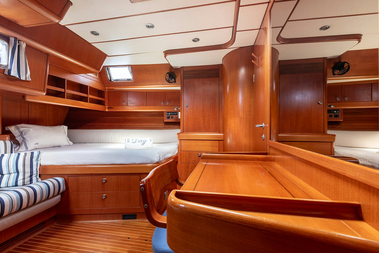 a cabin with a bed and a couch aboard DAG Yacht for Sale