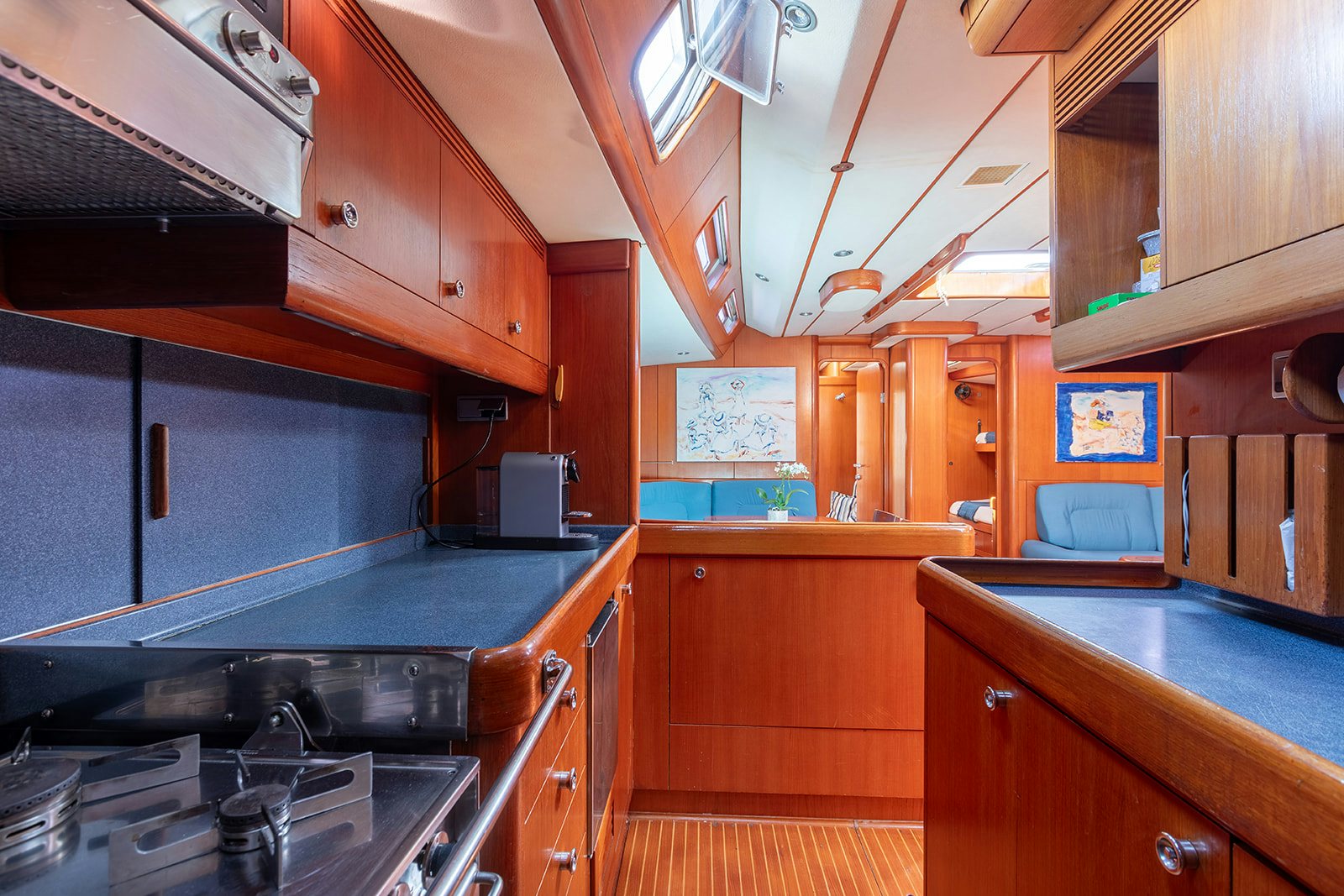 a kitchen with wooden cabinets aboard DAG Yacht for Sale
