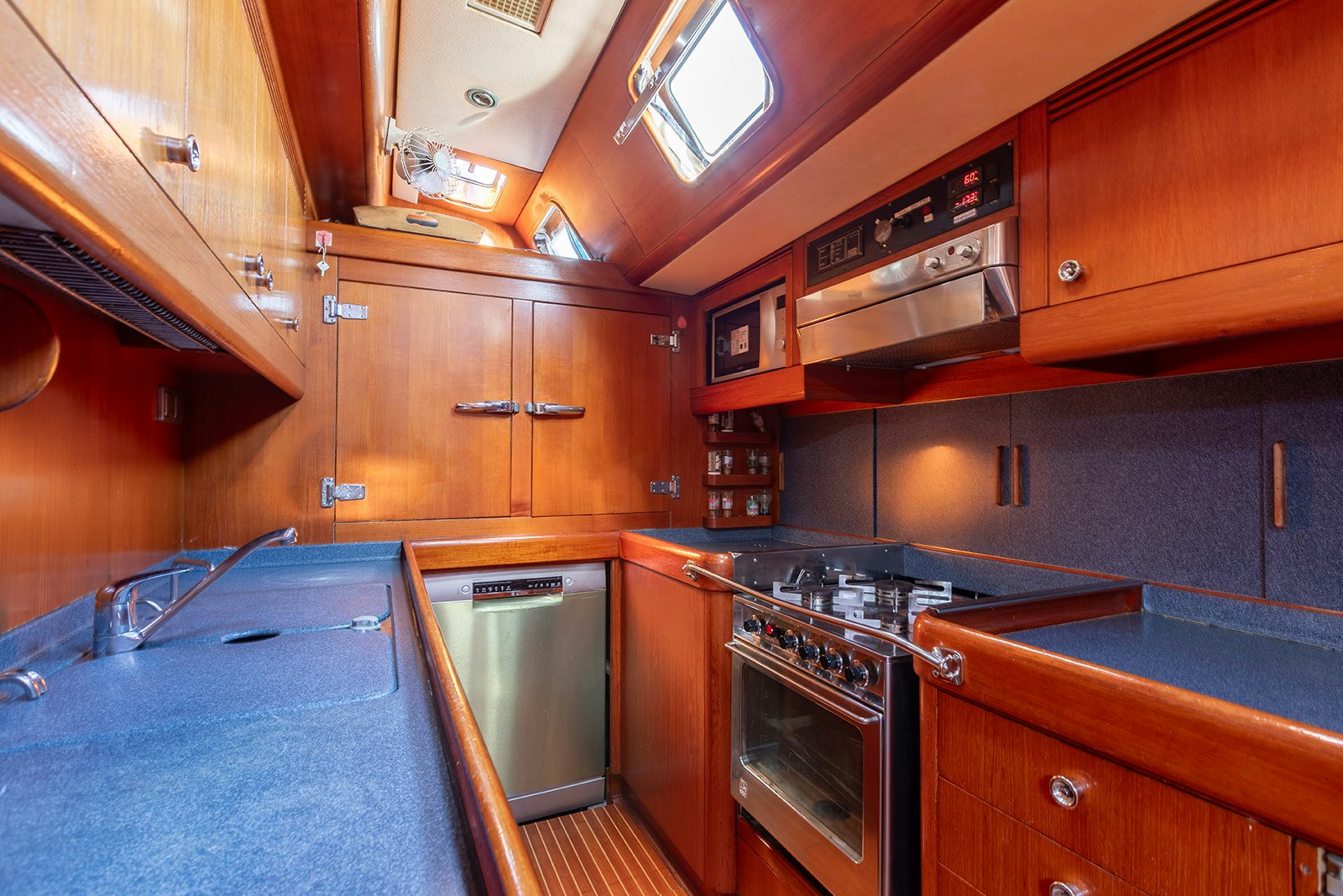 a kitchen with wooden cabinets aboard DAG Yacht for Sale