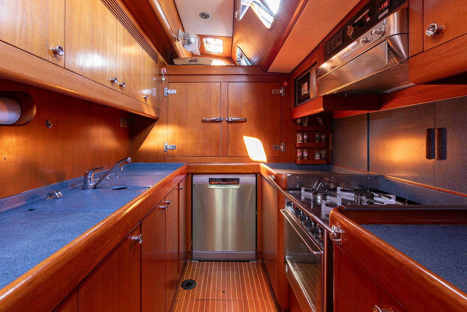 a kitchen with wooden cabinets aboard DAG Yacht for Sale