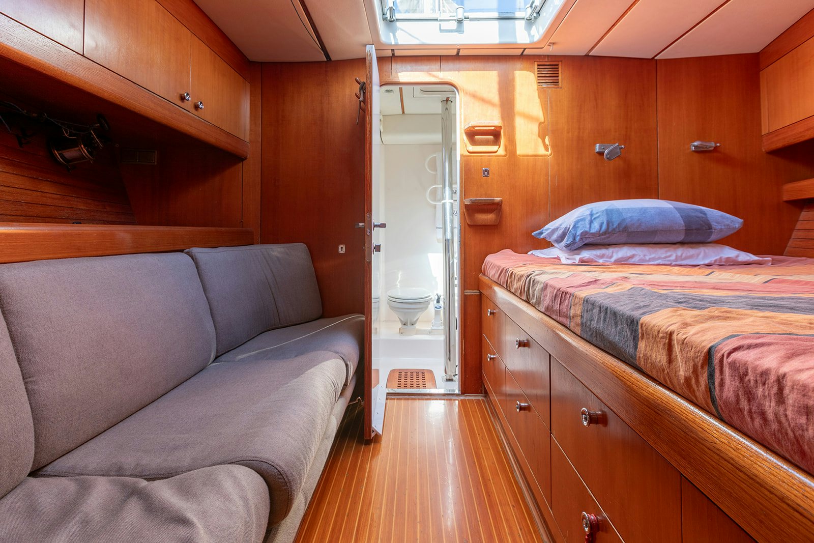 a room with a bed and a couch aboard DAG Yacht for Sale