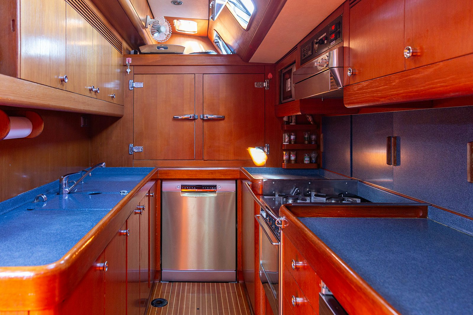 a kitchen with wooden cabinets aboard DAG Yacht for Sale