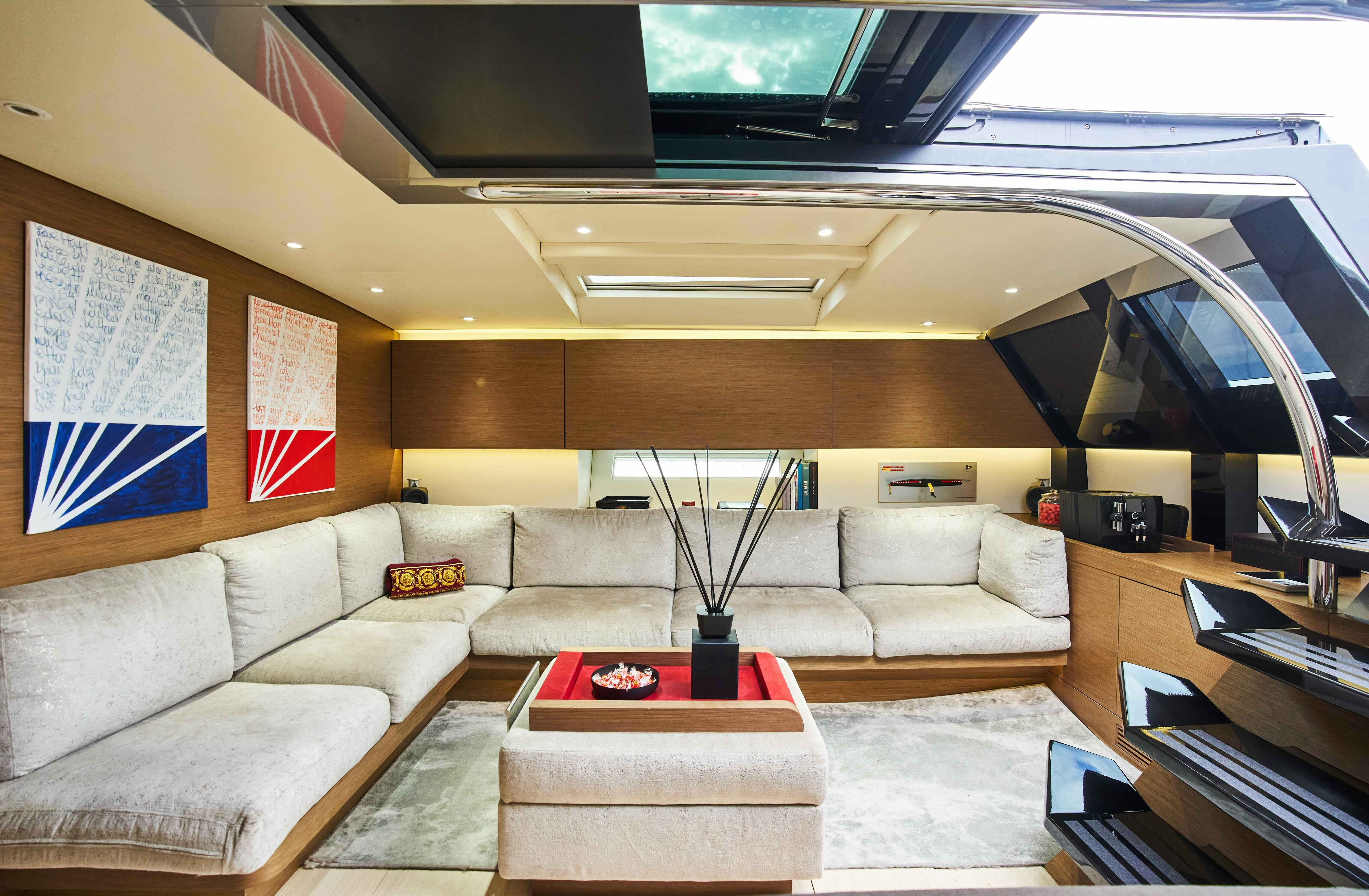 a living room with a couch and a tv aboard BLACK SAILS Yacht for Sale