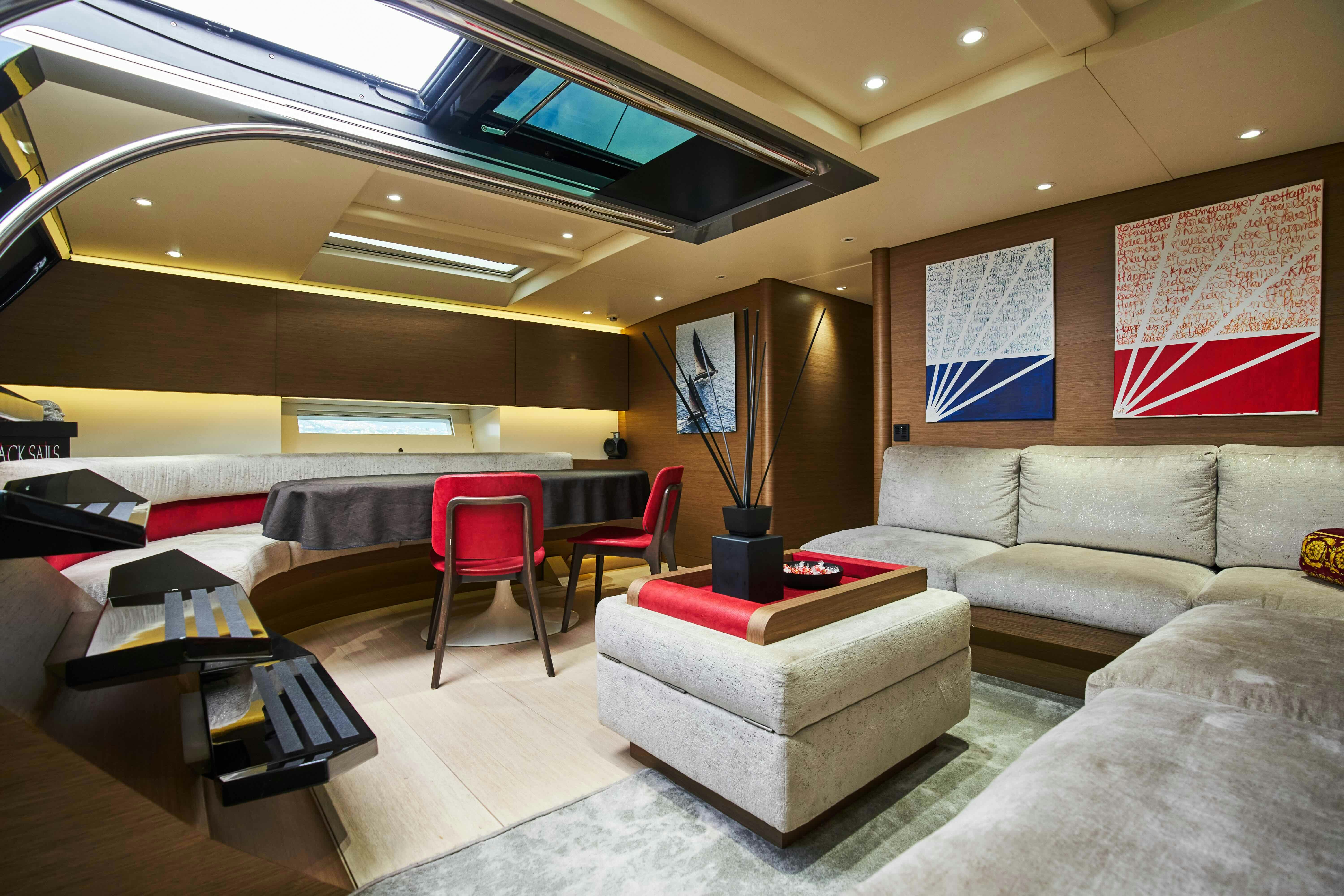 a living room with a couch and a table aboard BLACK SAILS Yacht for Sale