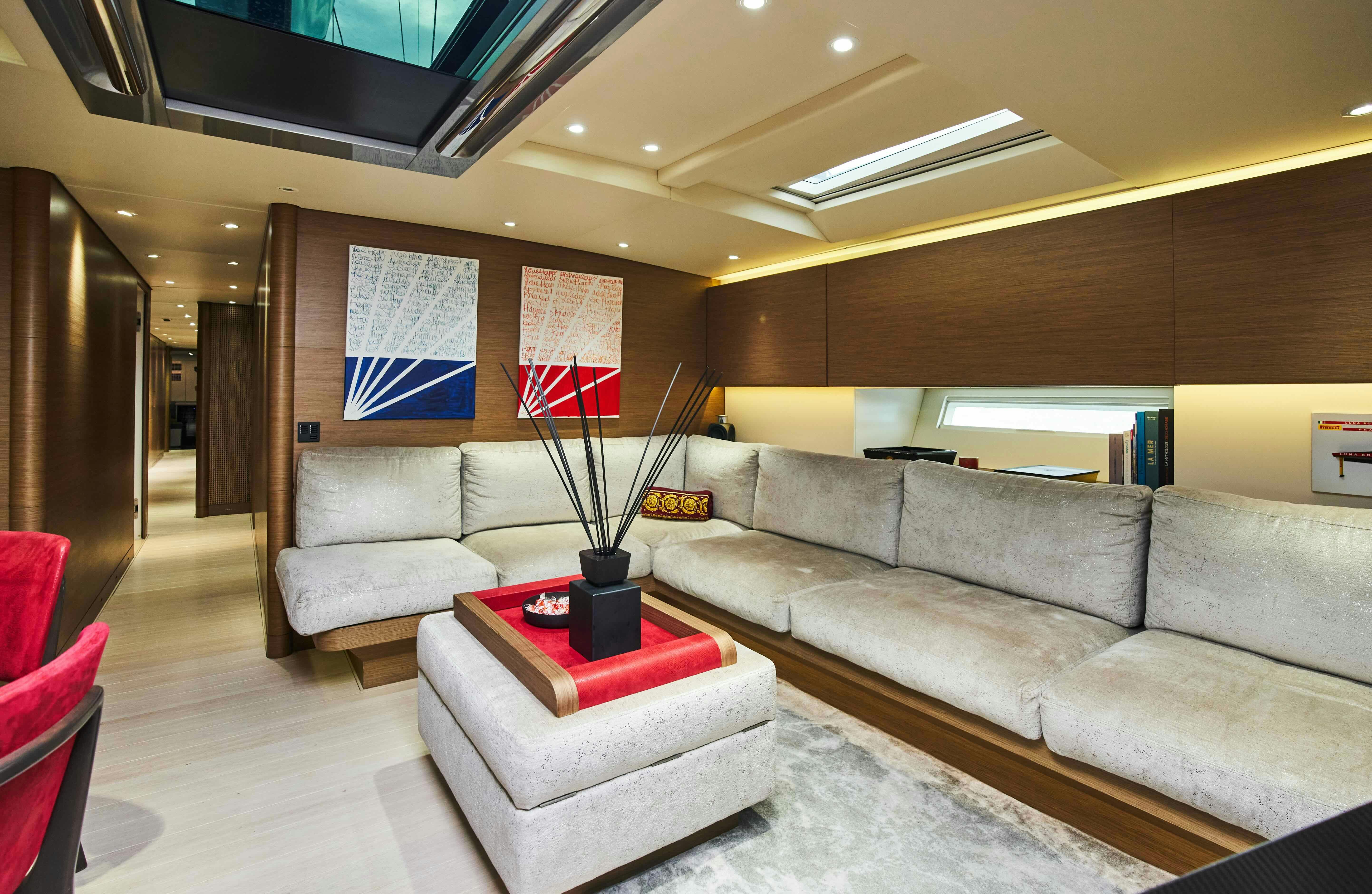 a living room with a couch and a tv aboard BLACK SAILS Yacht for Sale