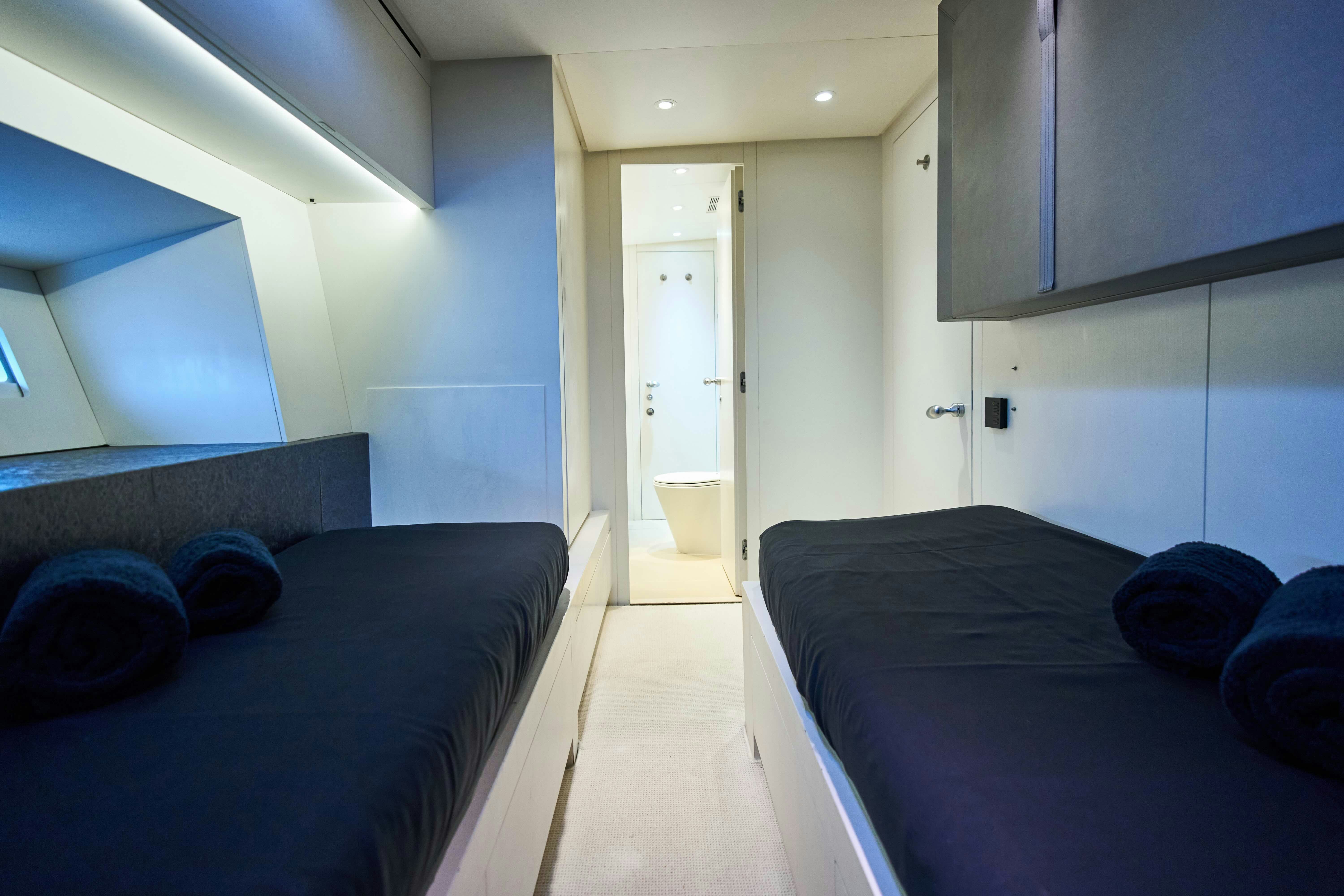a room with a bed and a blue bed aboard BLACK SAILS Yacht for Sale