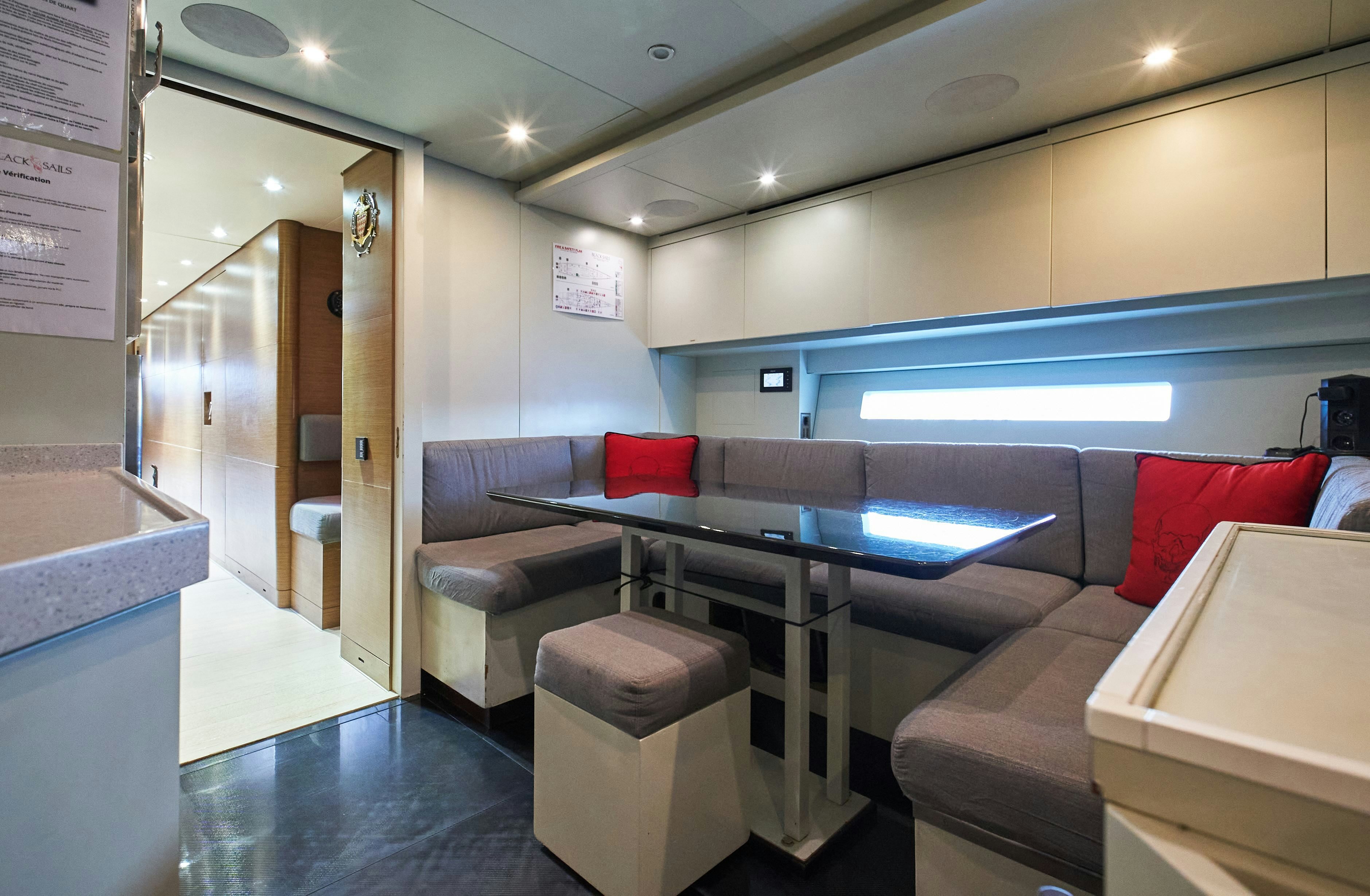 a room with a table and couches aboard BLACK SAILS Yacht for Sale