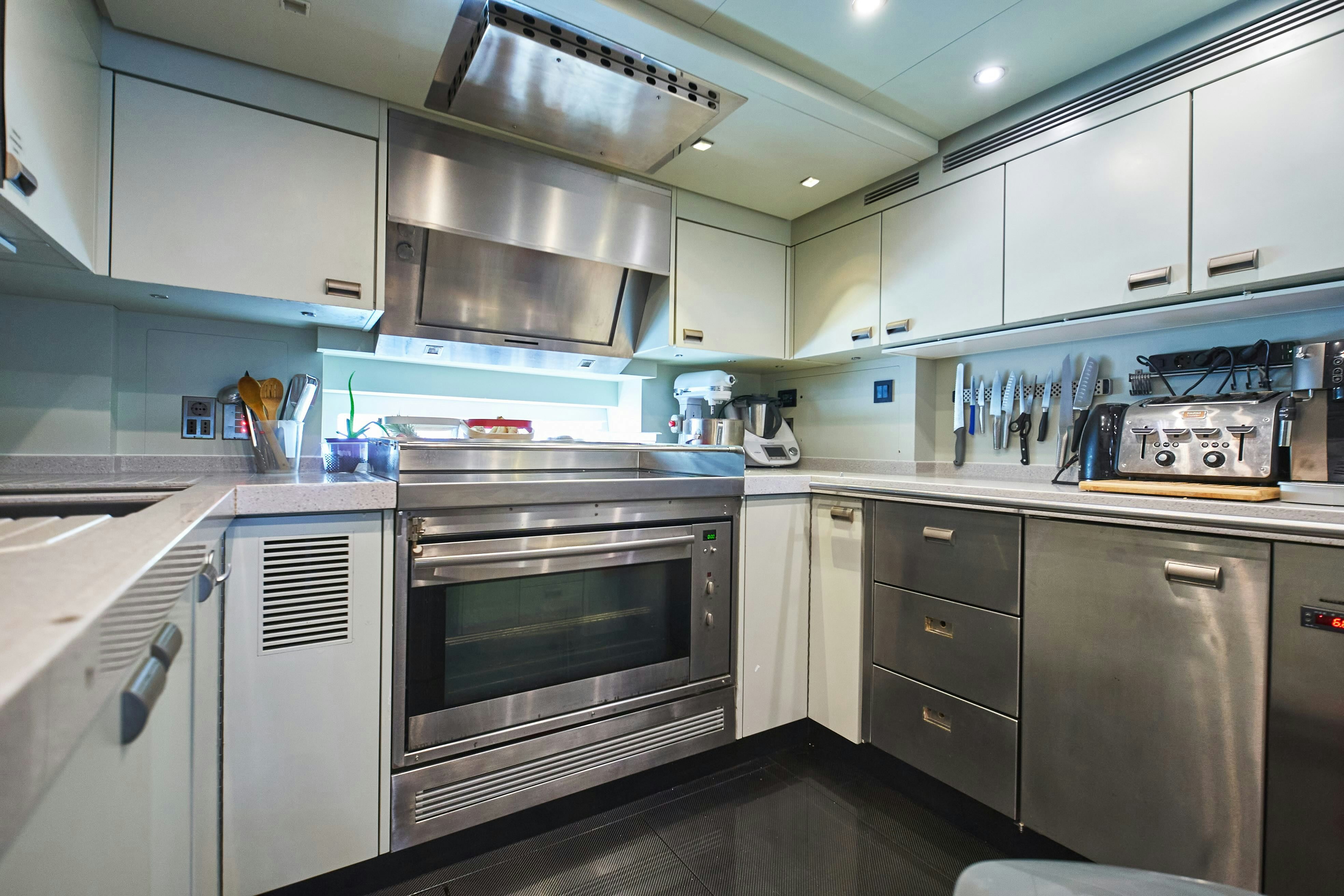 a kitchen with stainless steel appliances aboard BLACK SAILS Yacht for Sale