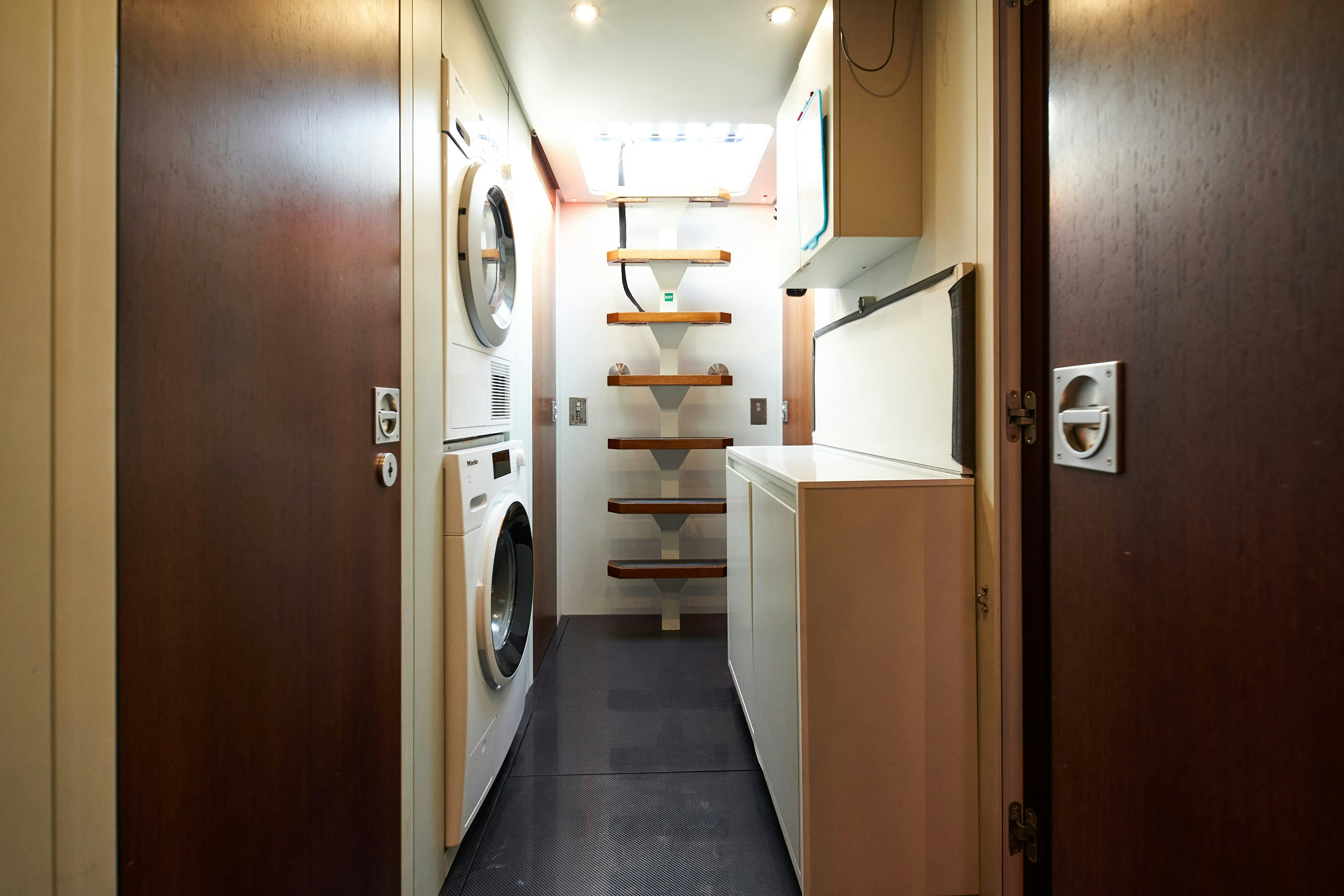 a hallway with a door and cabinets aboard BLACK SAILS Yacht for Sale