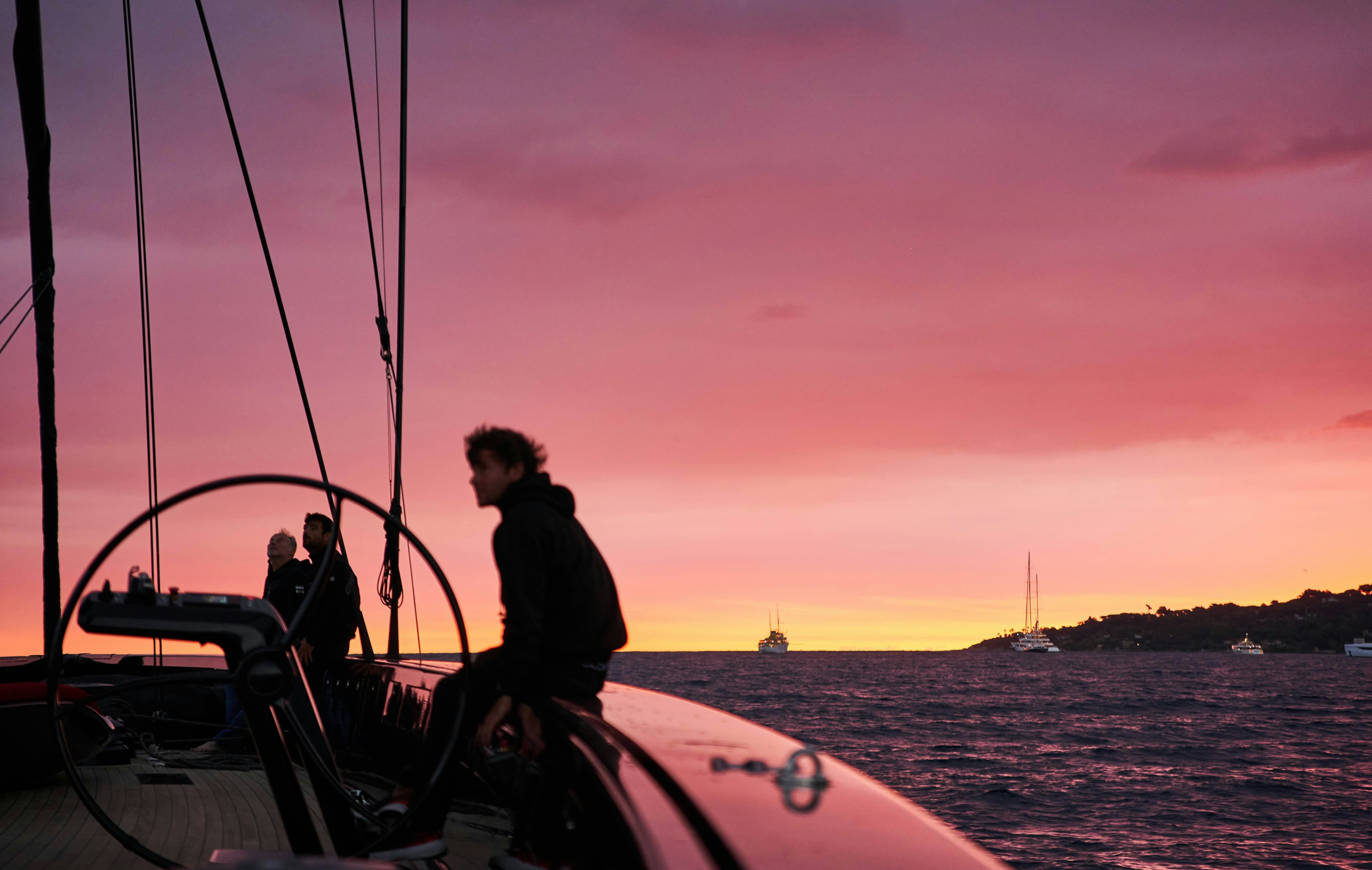 a group of people on a boat at sunset aboard BLACK SAILS Yacht for Sale