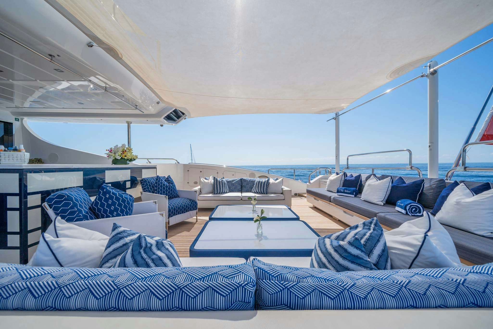 a large living room with a large blue ocean aboard DA VINCI Yacht for Charter