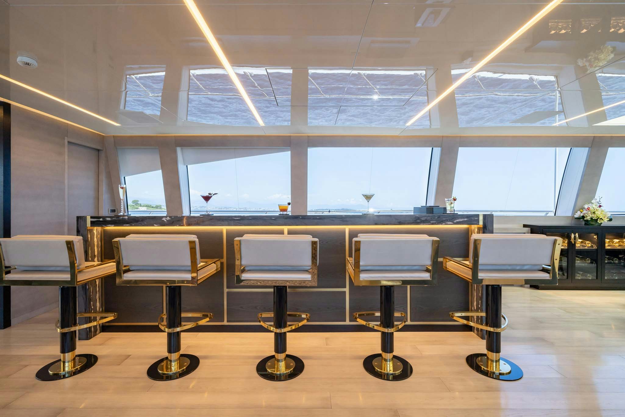 a room with tables and chairs aboard DA VINCI Yacht for Charter