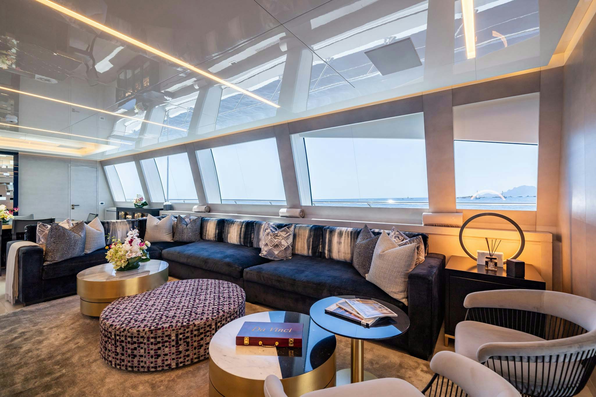 a living room with a large window aboard DA VINCI Yacht for Charter