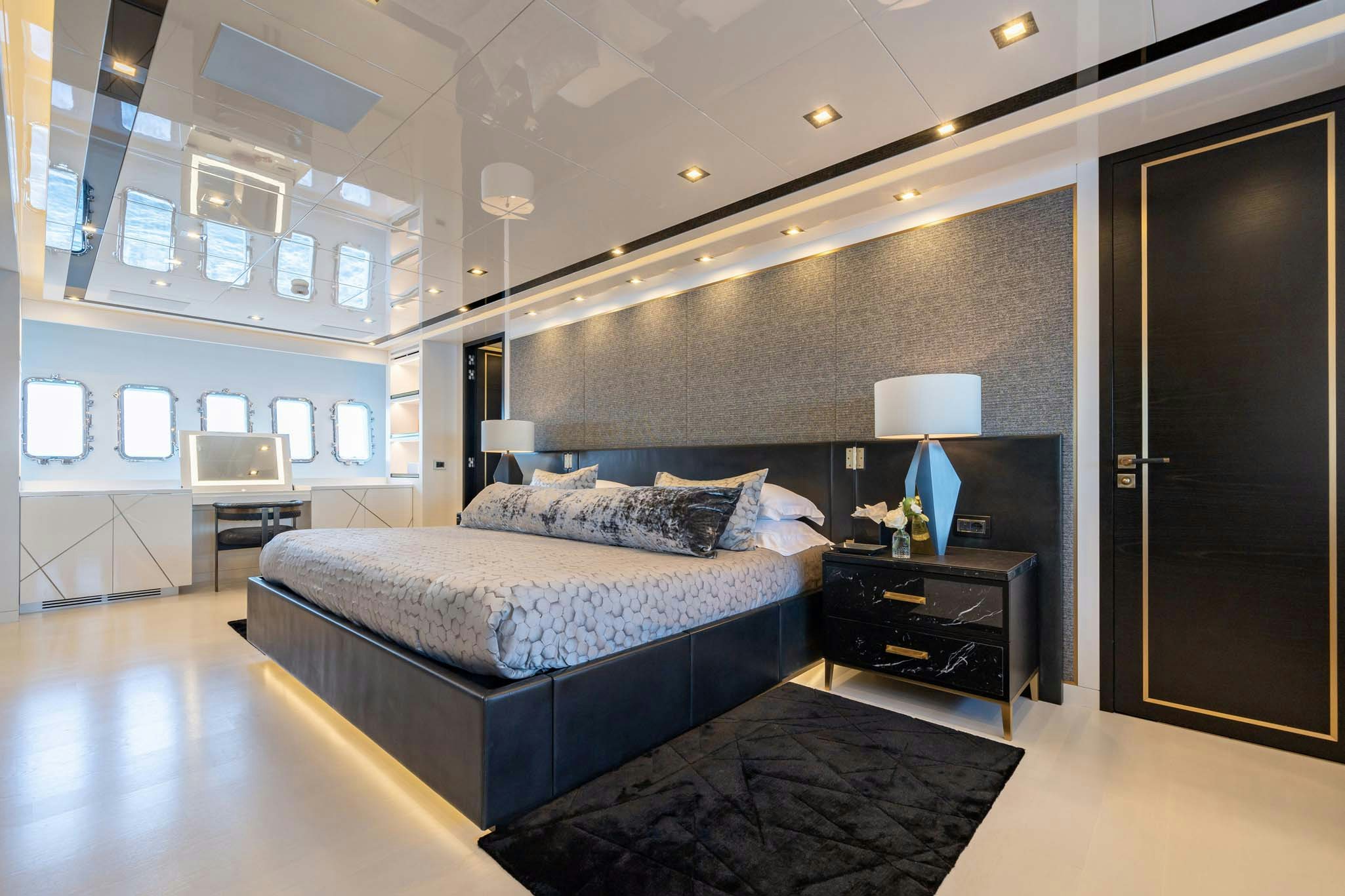 a bedroom with a bed and a desk aboard DA VINCI Yacht for Charter